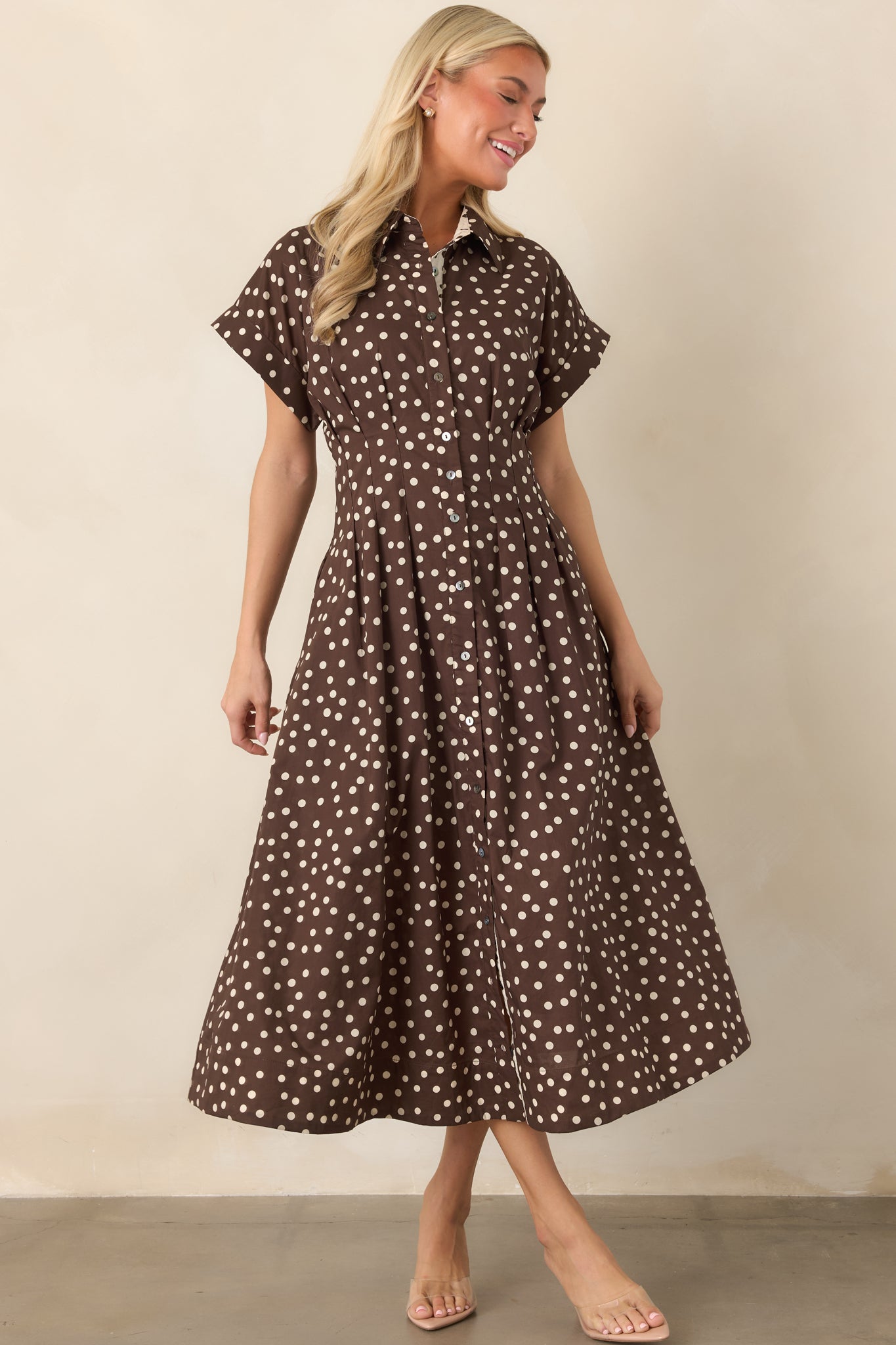 Brown and ivory cotton midi dress with tailored waist seams, a full button closure, collared neckline, short sleeves, and relaxed flared skirt.
