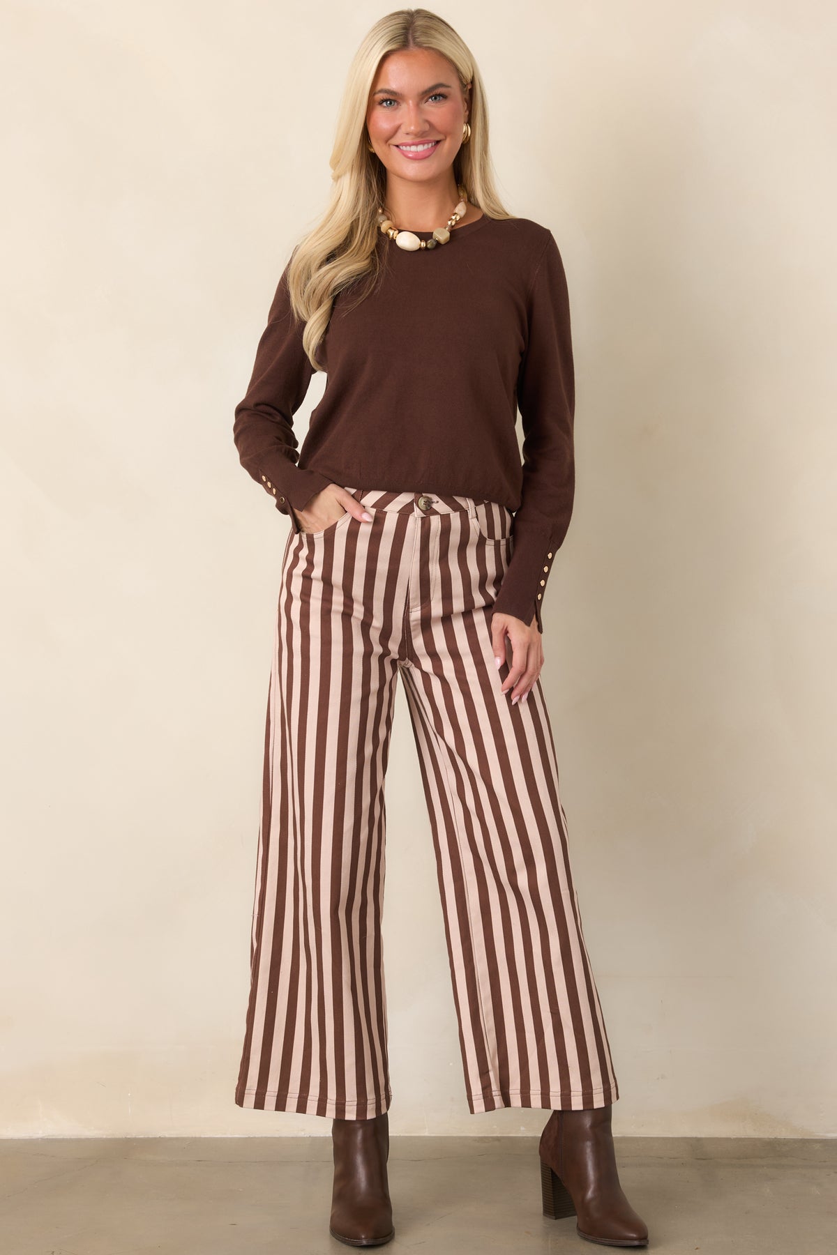 Cropped wide-leg pants in a brown and ivory vertical stripe pattern, featuring a polished structured silhouette and functional pockets.
