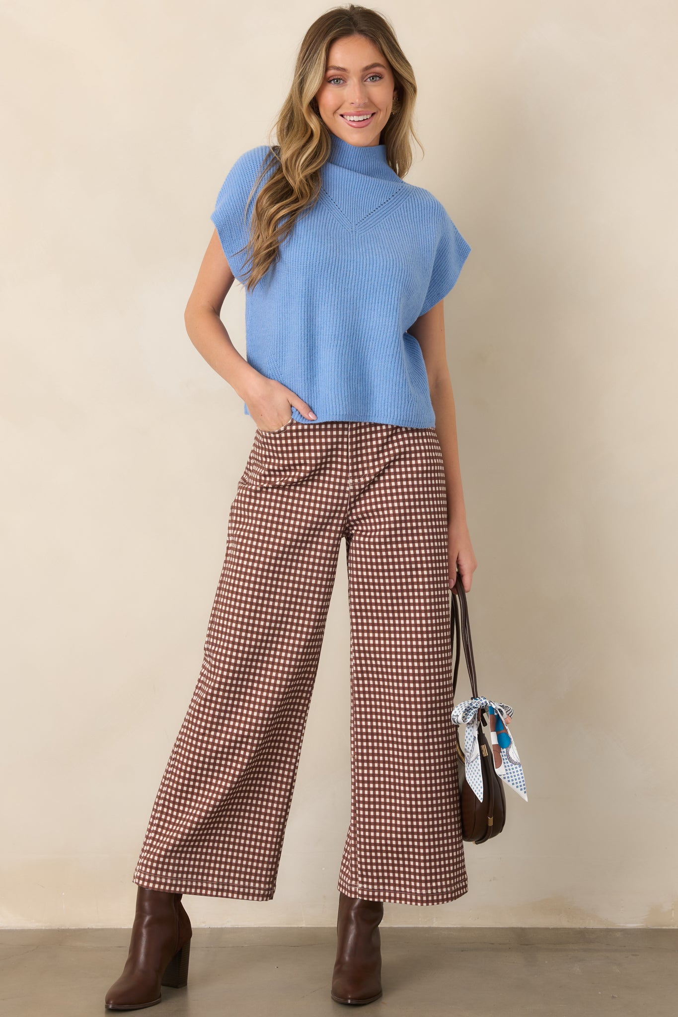 Brown and ivory gingham pants featuring a high-rise waist, relaxed wide-leg silhouette, belt loops, and classic zip-and-button closure.