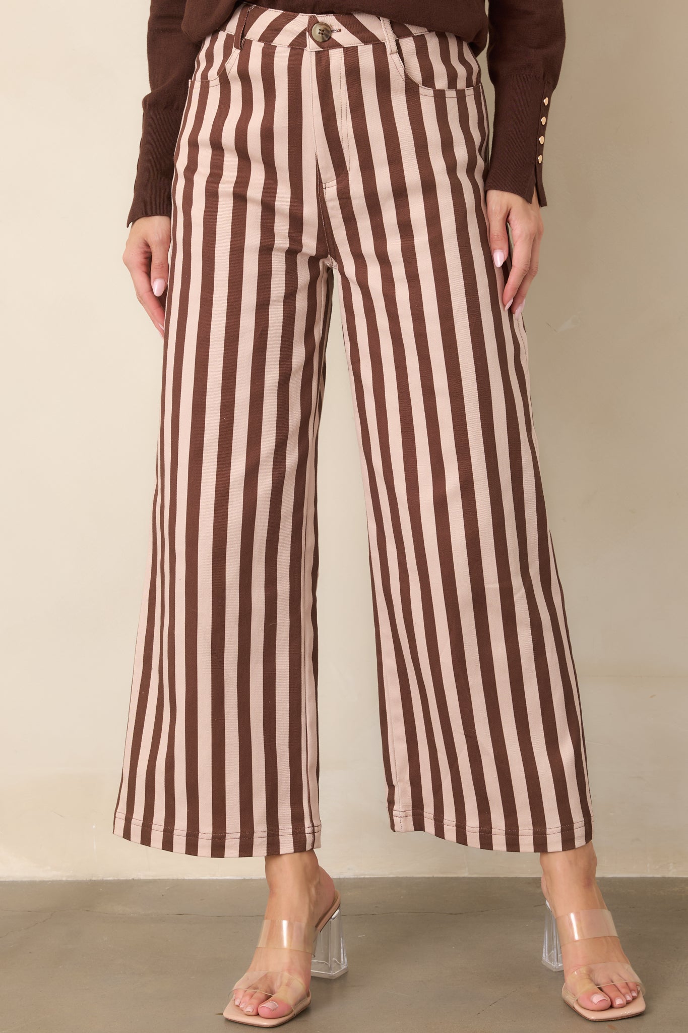Brown and ivory vertical stripes accent the high-rise waist and wide-leg shape of these cropped cotton-blend pants.