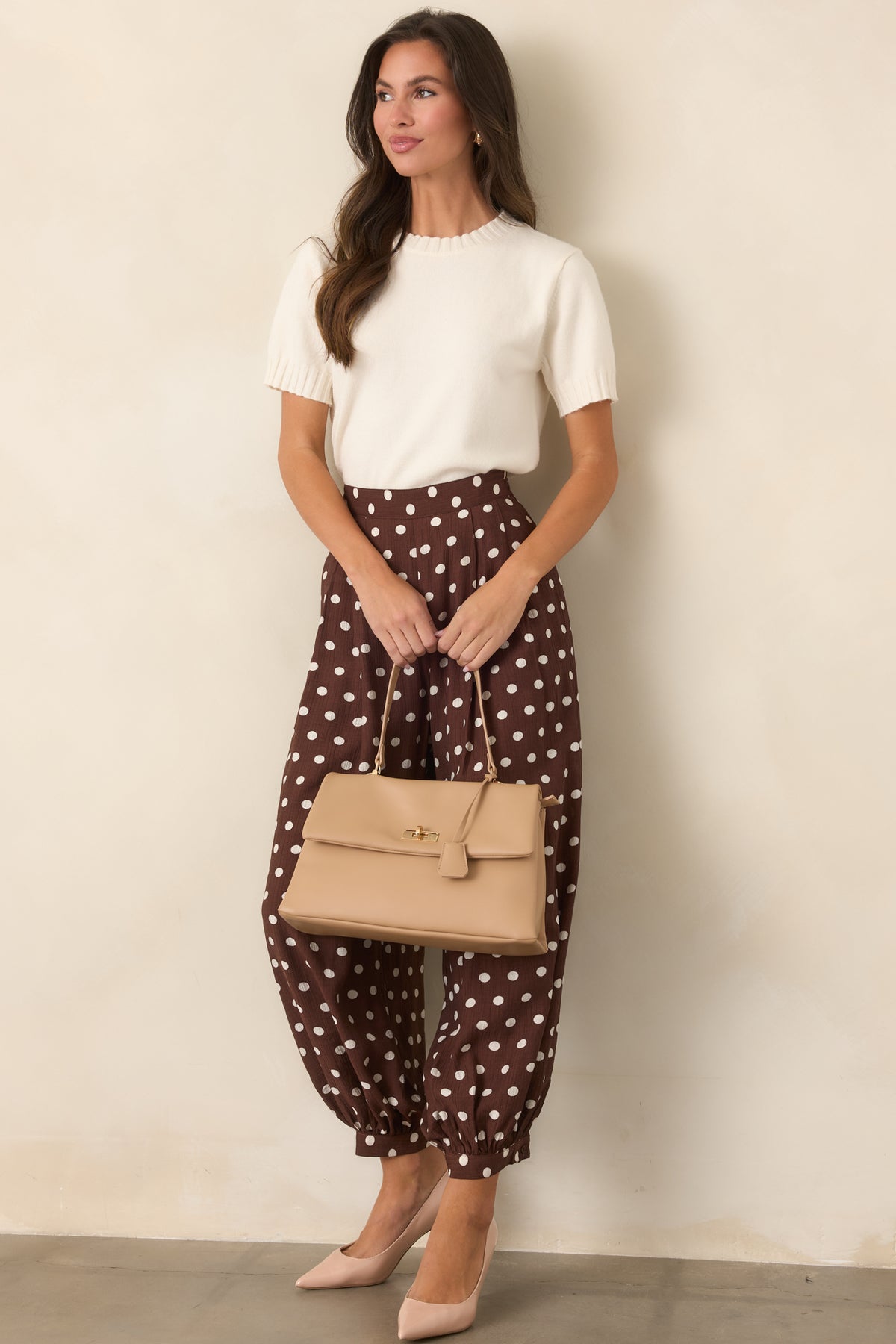 Vintage-inspired brown pants with ivory dots, front pleats, side pockets, and gathered ankle cuffs.