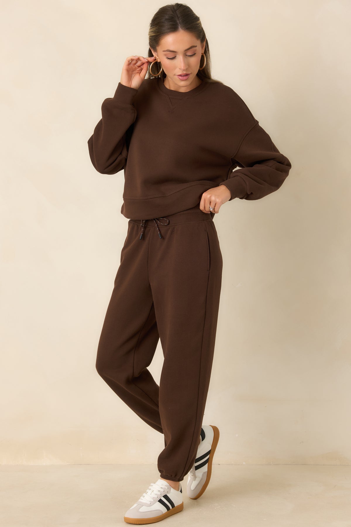 Brown joggers featuring a relaxed tapered-leg silhouette and adjustable drawstring waistband.