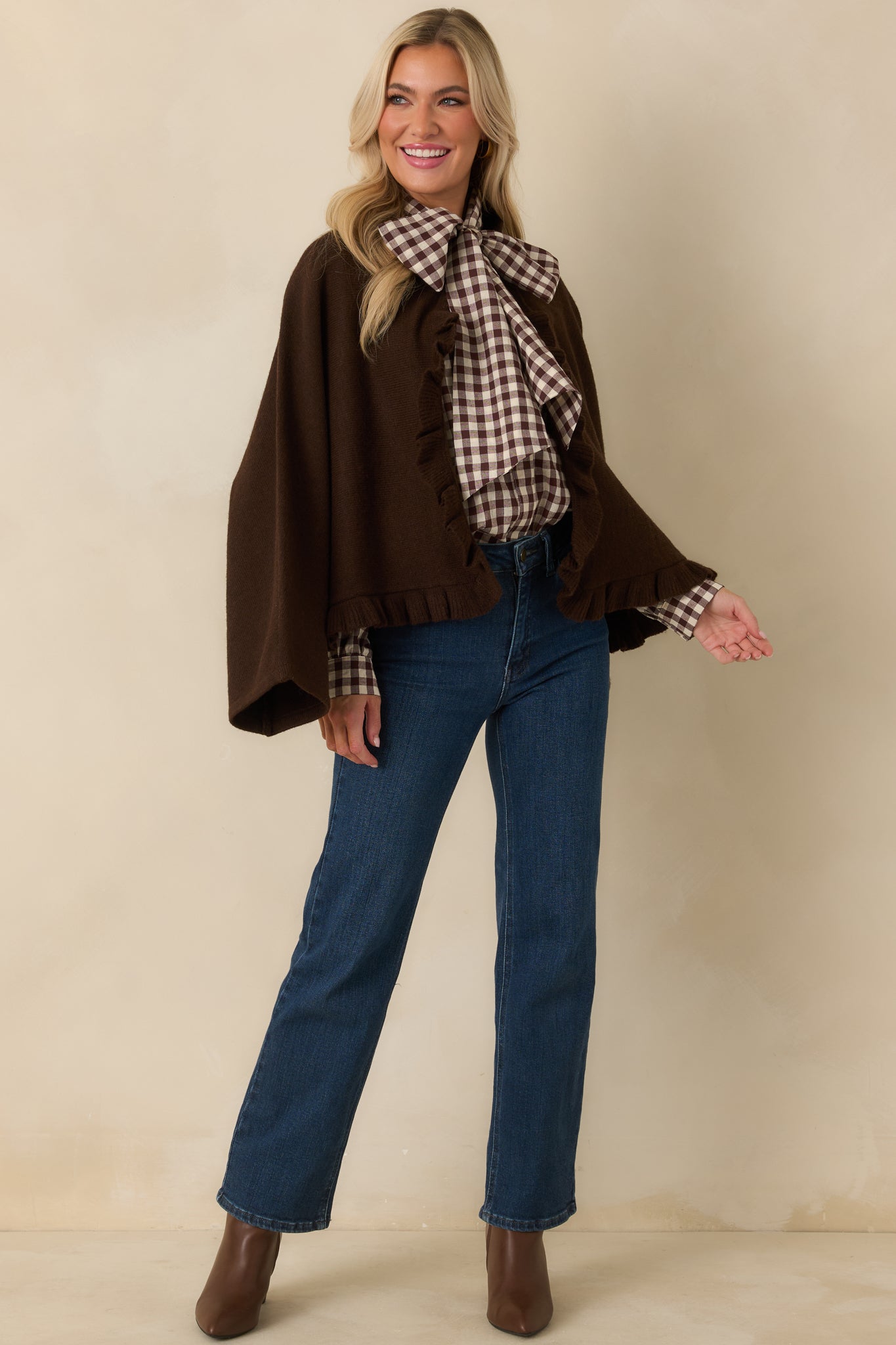 Front angled view of brown knit cardigan showing its relaxed drape, wide sleeves, and ruffled front opening.