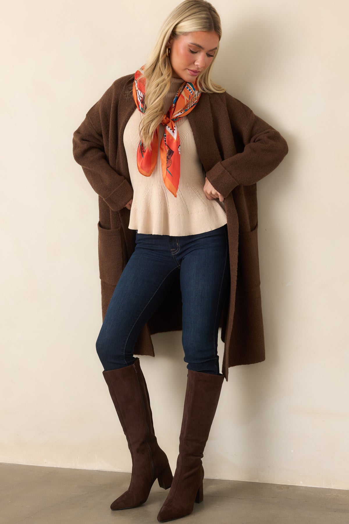 Soft brown knit cardigan defined by a draped shawl collar, dropped shoulders, and an easy open-front design.