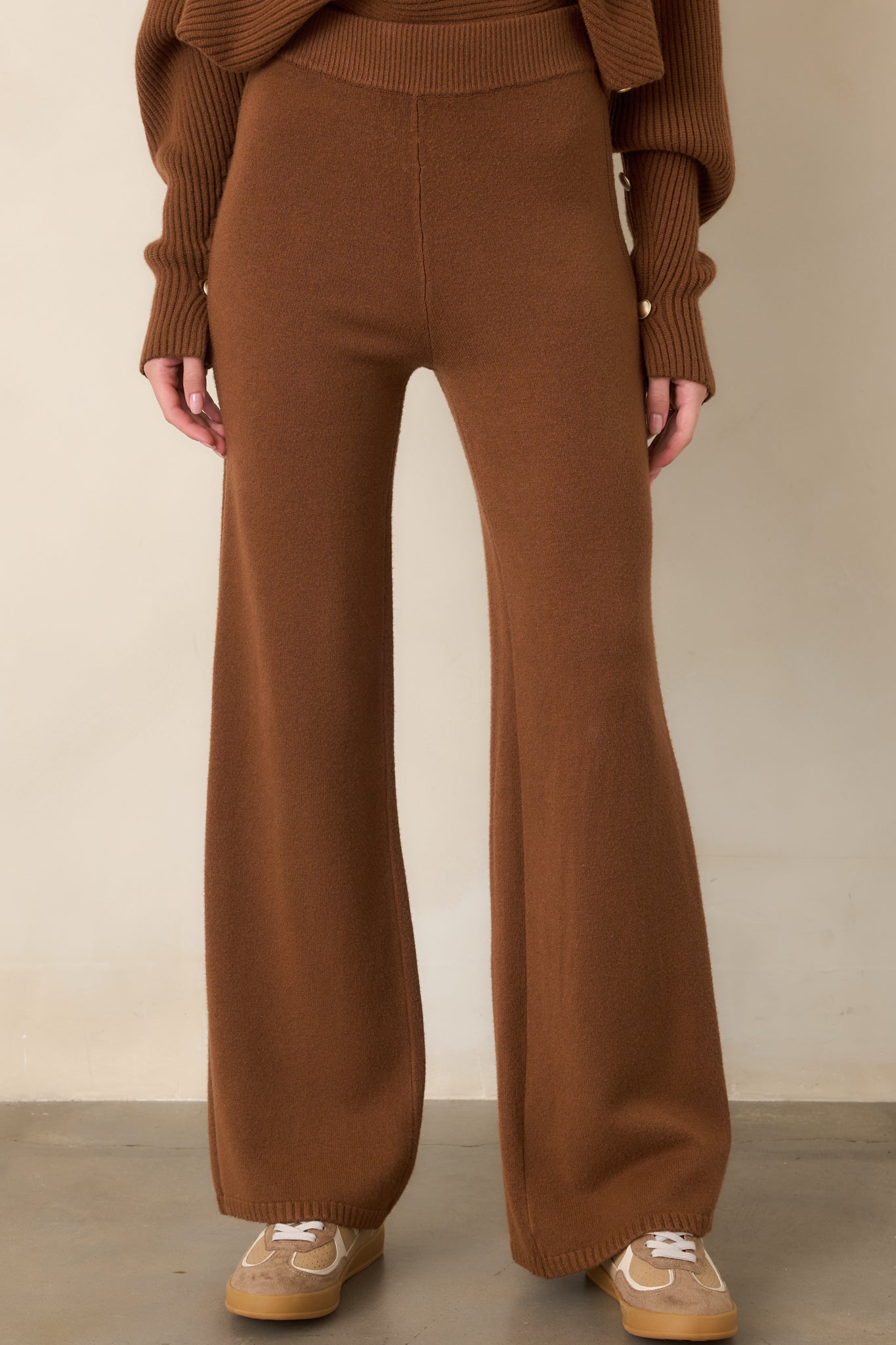 Detailed view of the soft brown knit fabric showcasing the subtle ribbed side detailing and wide-leg construction.