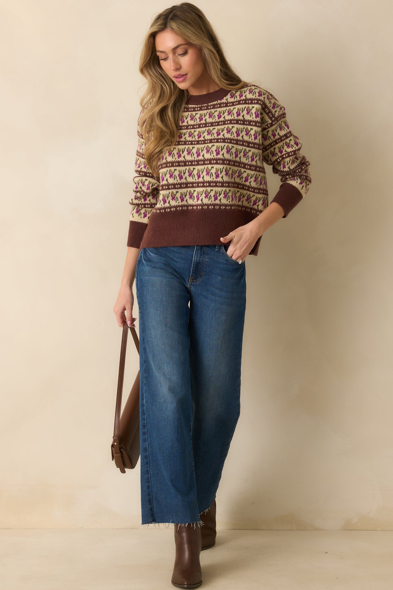 Long-sleeve brown knit sweater emphasizing the structured crew neckline and patterned winter-inspired motif.