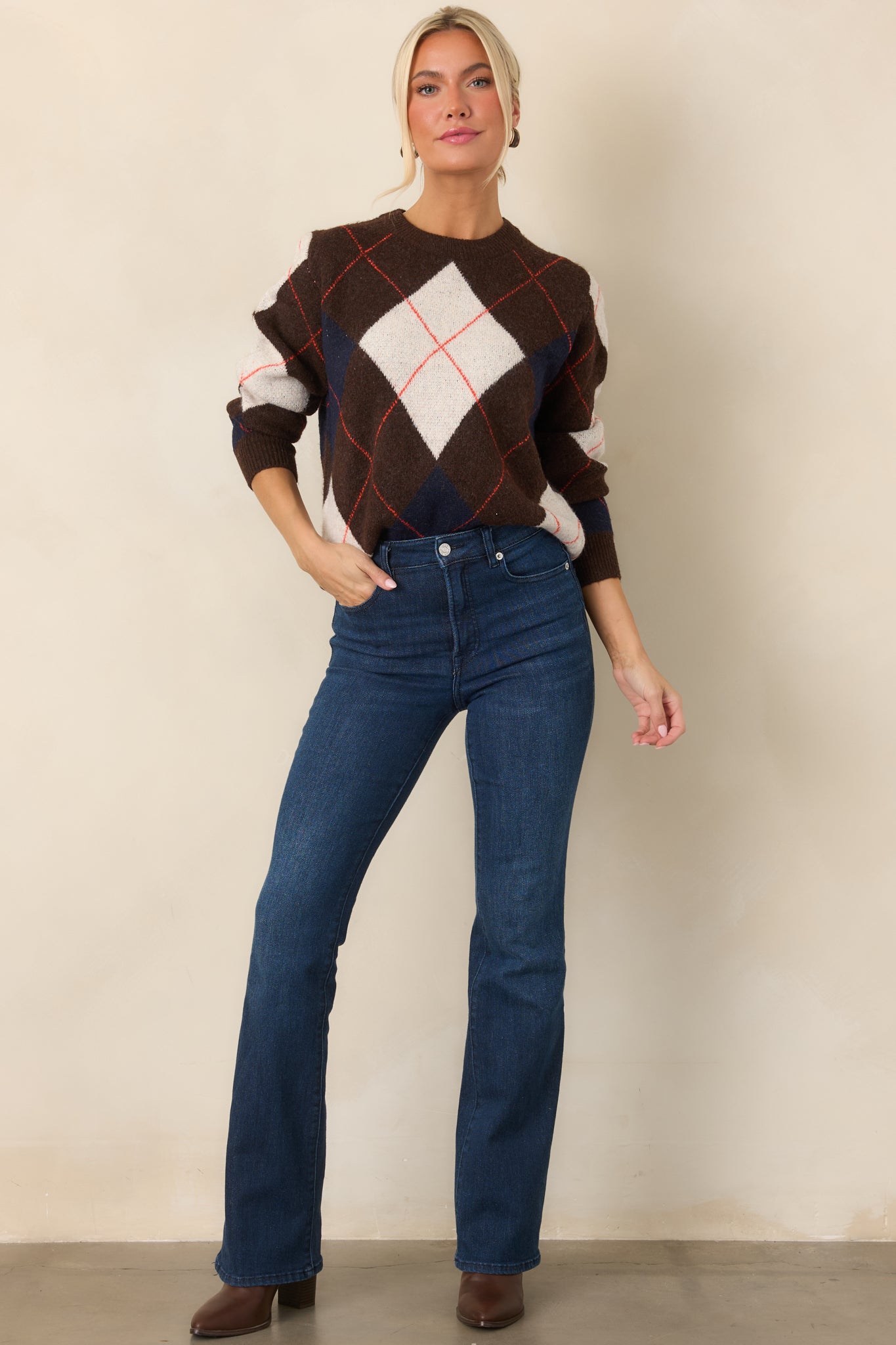Soft knit top showcasing a rich brown base, colorful geometric pattern, crew neckline, and ribbed trims.
