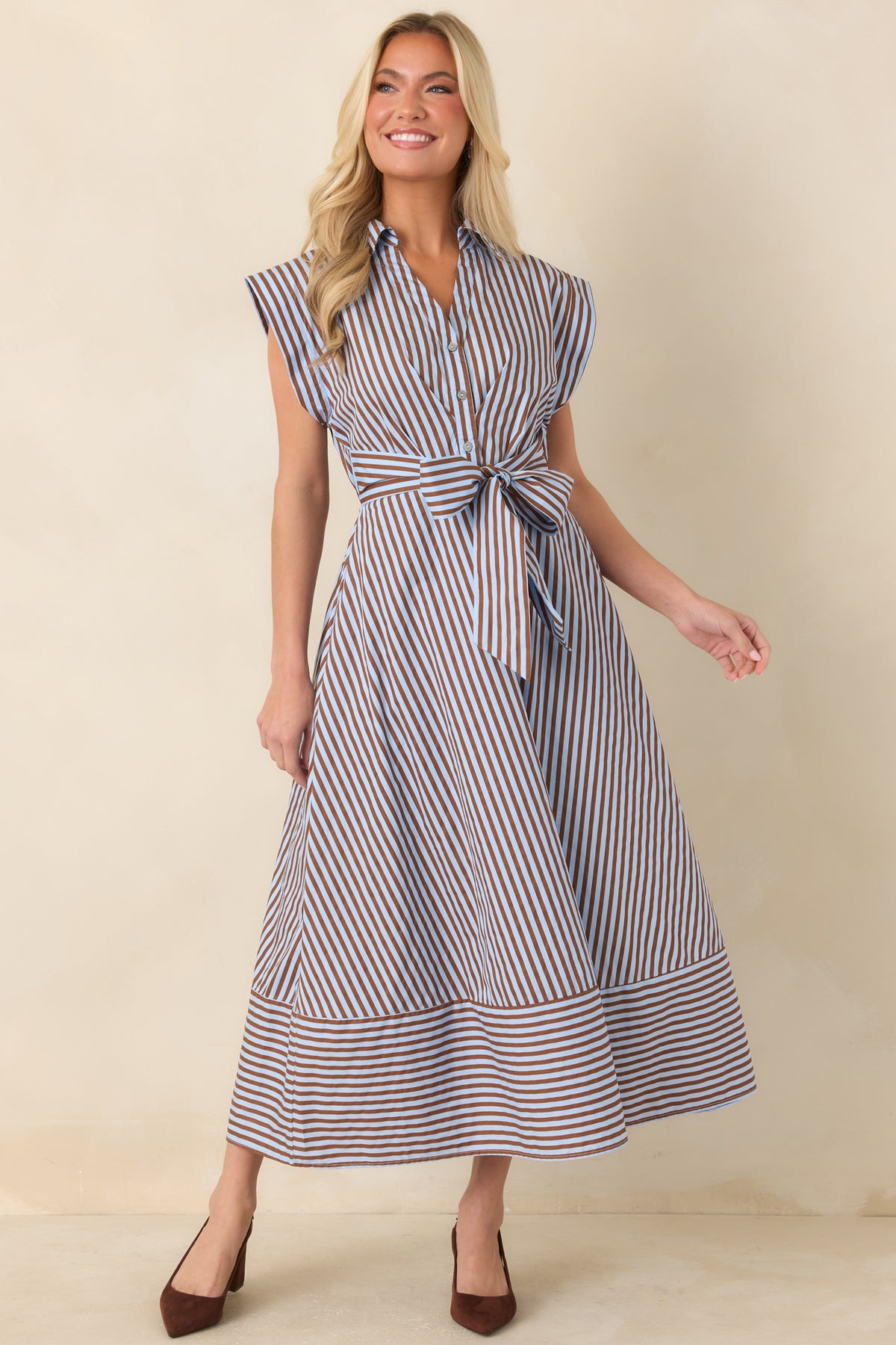 Brown and light blue striped midi dress with a collared neckline, cap sleeves, and a statement waist bow.