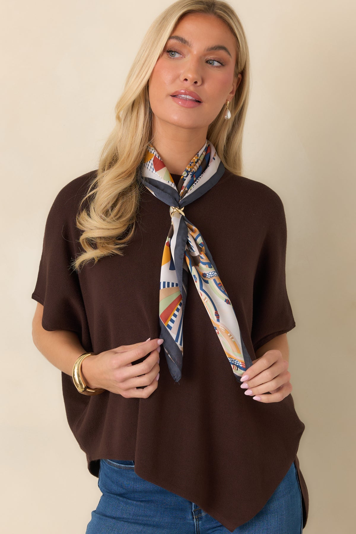 Lightweight brown knit top featuring a wide sleeve opening and a loose, flowing silhouette.