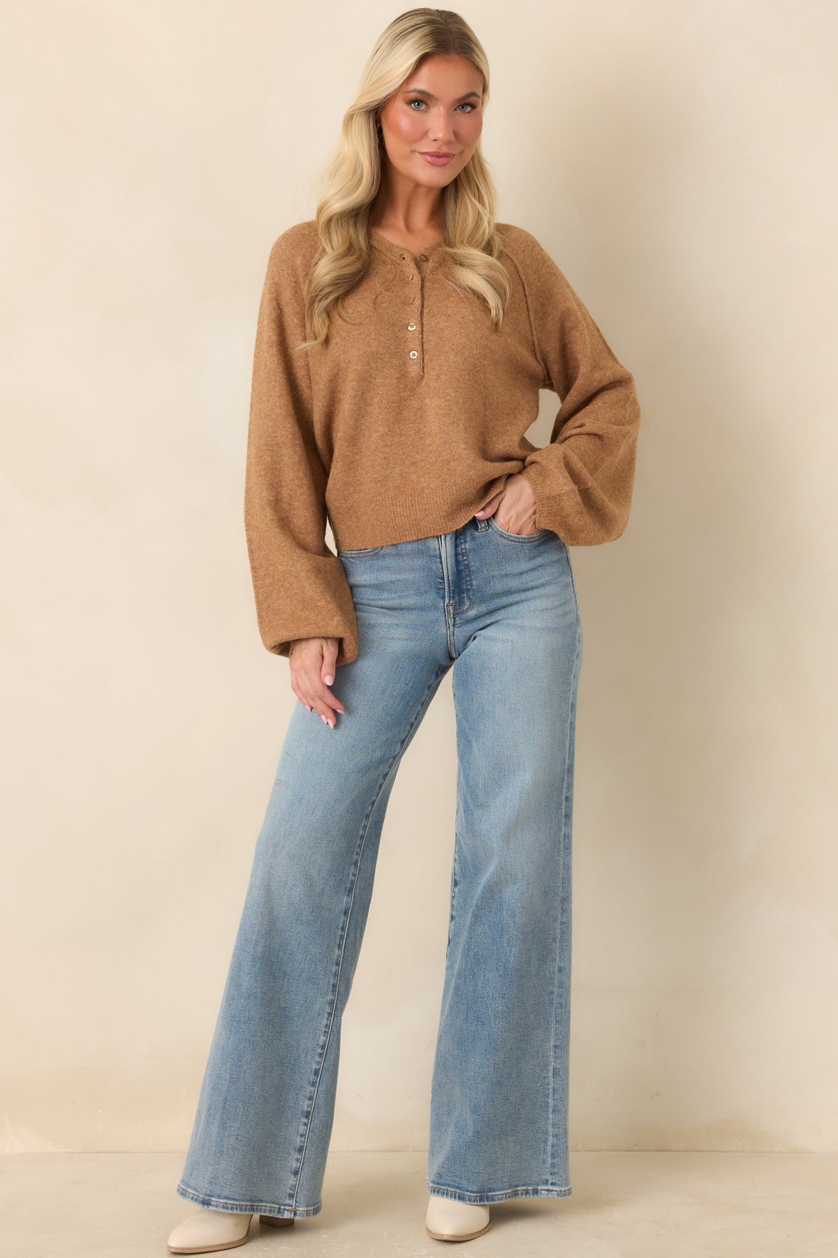 Brown long-sleeve Henley top with a classic neckline, gently gathered ribbed cuffs, and a neat ribbed hem.