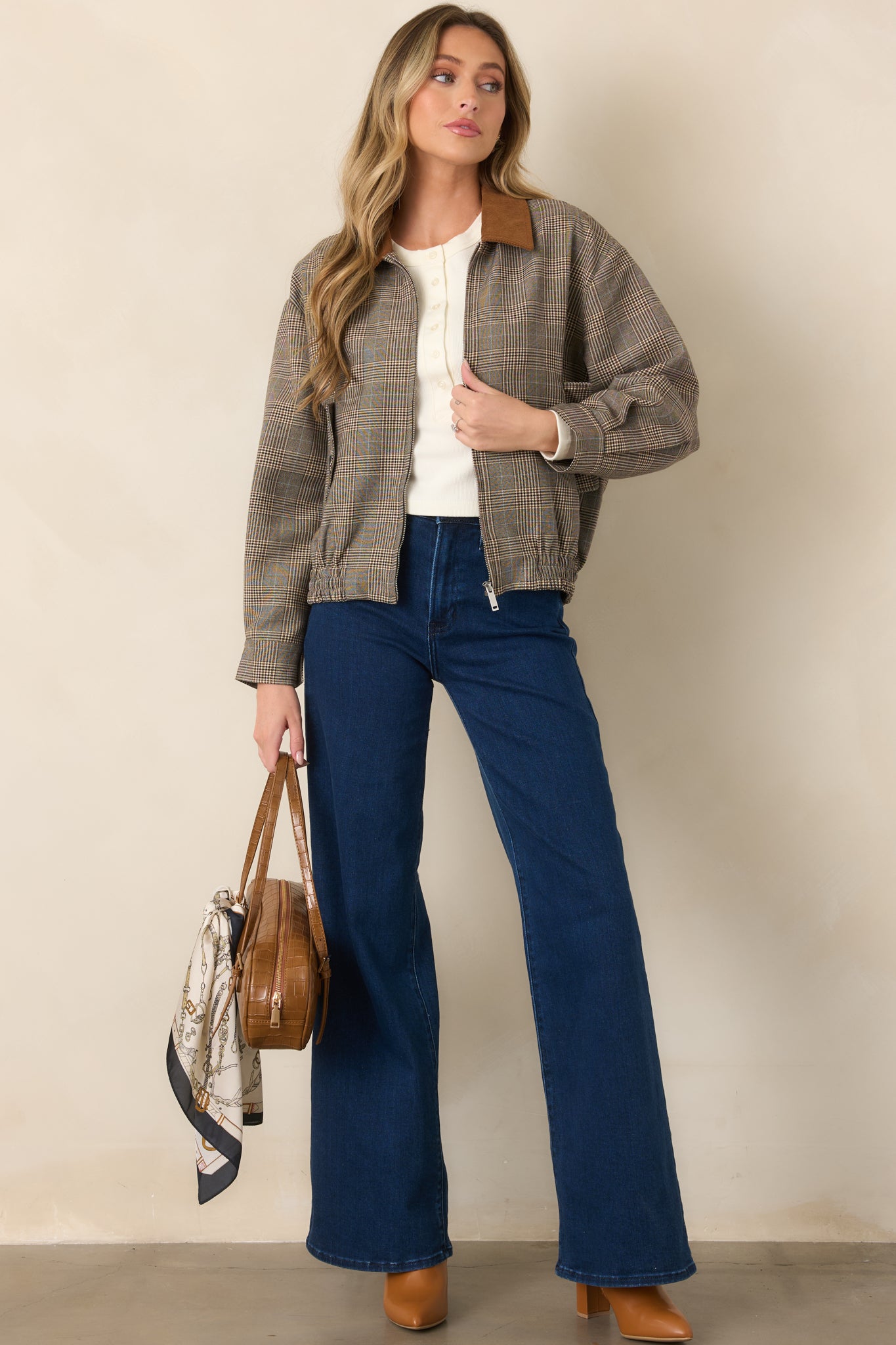 Brown multi-plaid woven bomber jacket with a contrasting corduroy collar, front button flap pockets, front zip closure, and elastic hem.