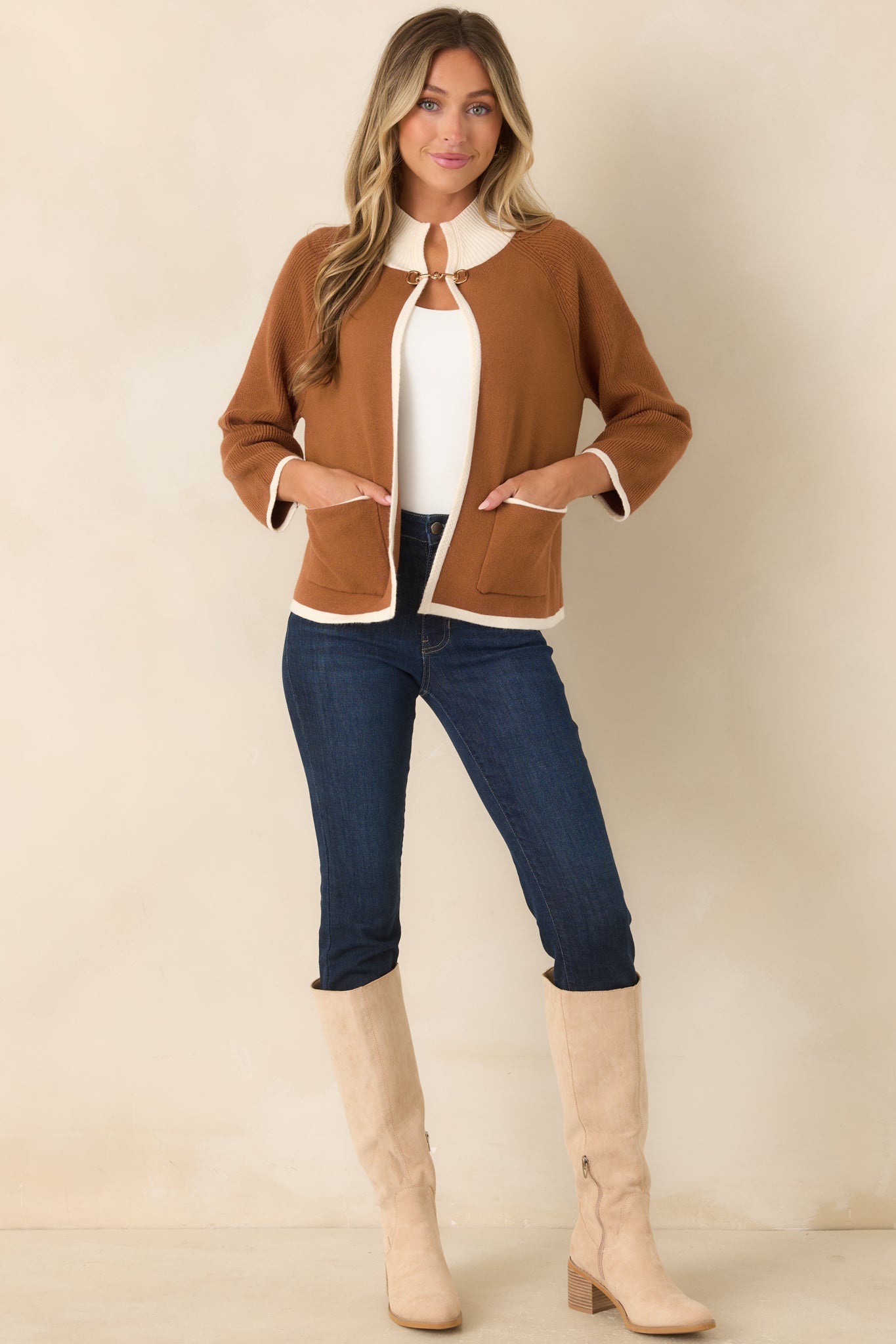 Brown open-front cardigan designed with contrasting ivory trim, functional patch pockets, ribbed edges, and a refined gold-tone horsebit accent.