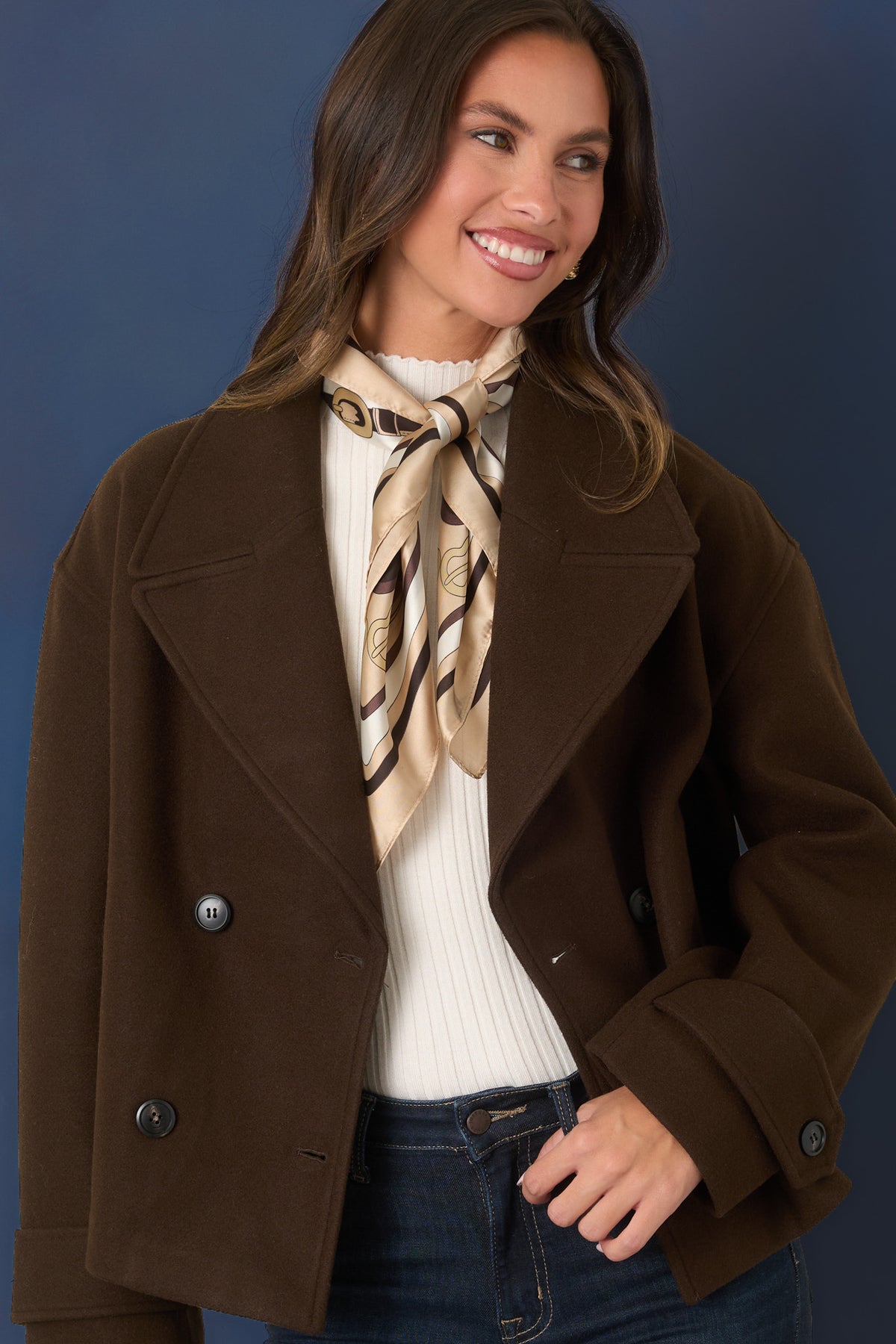  Chocolate brown jacket highlighting the oversized notched lapels and double-breasted button front.