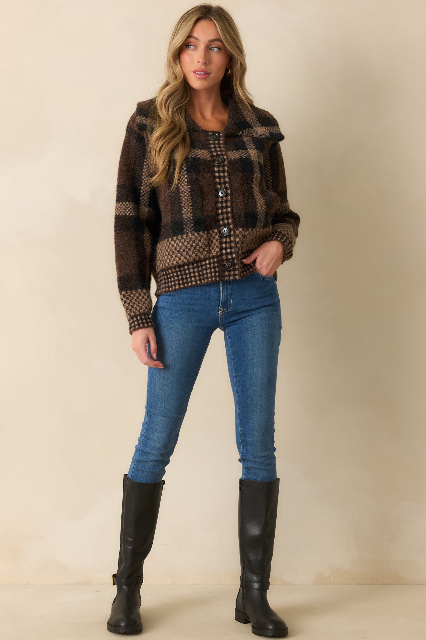 Brown cardigan with multicolor plaid pattern, wide notched collar, and full button front closure.