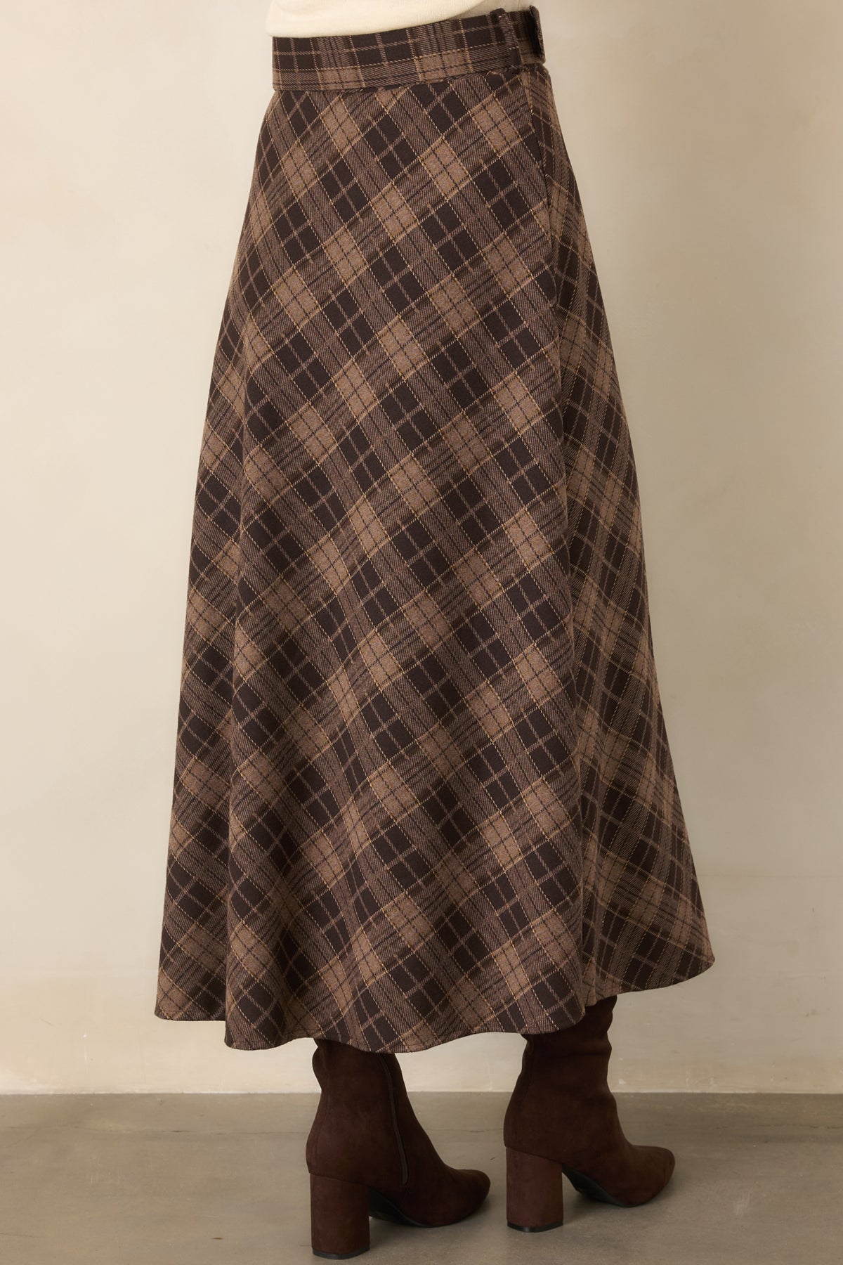 Rear of the brown plaid maxi skirt showing the sweeping A-line silhouette and flowing hem.
