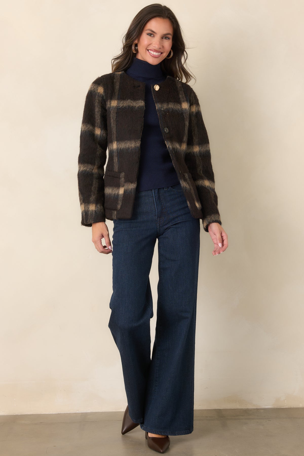 Brown plaid jacket featuring a gently shaped waist, concealed button front, and long sleeves.