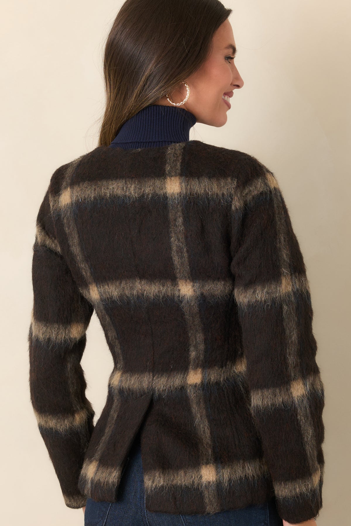 Rear view of the brown plaid wool-blend jacket showing the shaped waist, long sleeves, and back vent.
