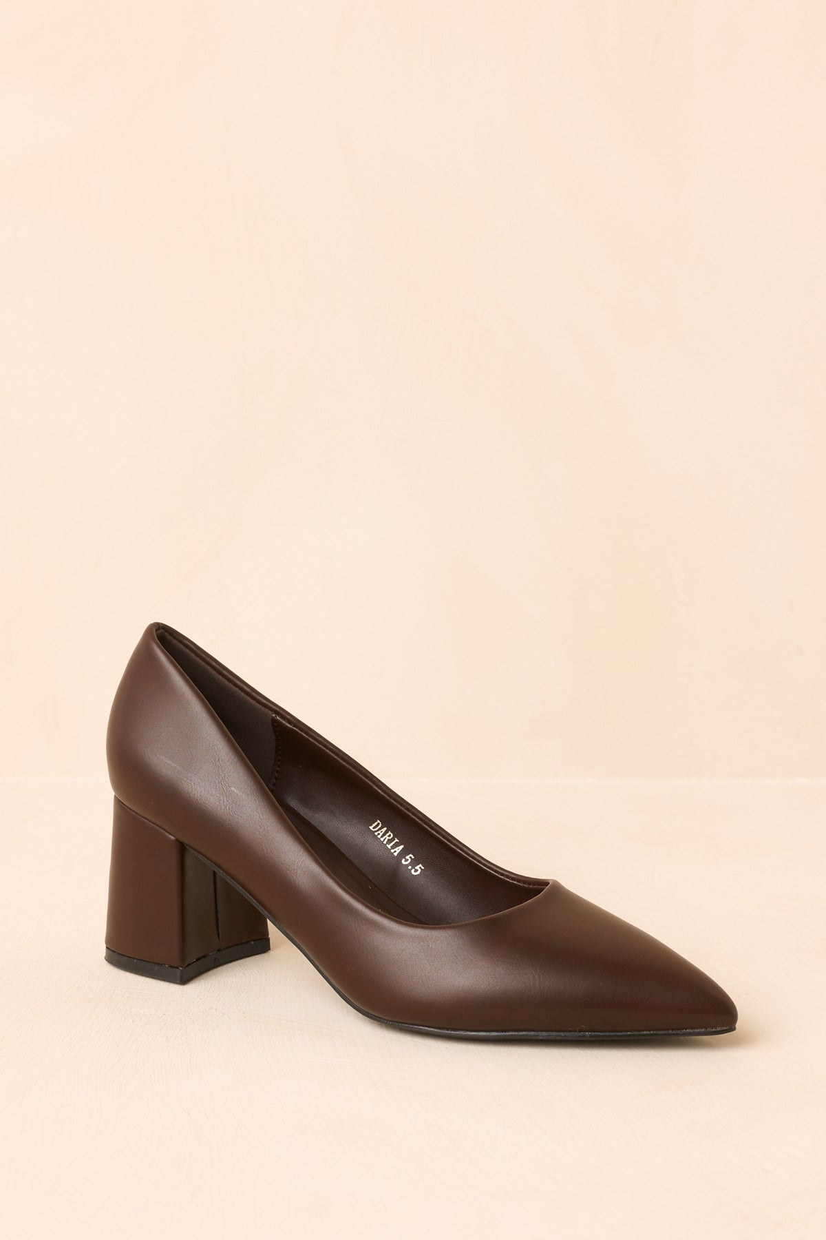 Brown slip-on heels showcasing the pointed toe and covered block heel from an angled view.