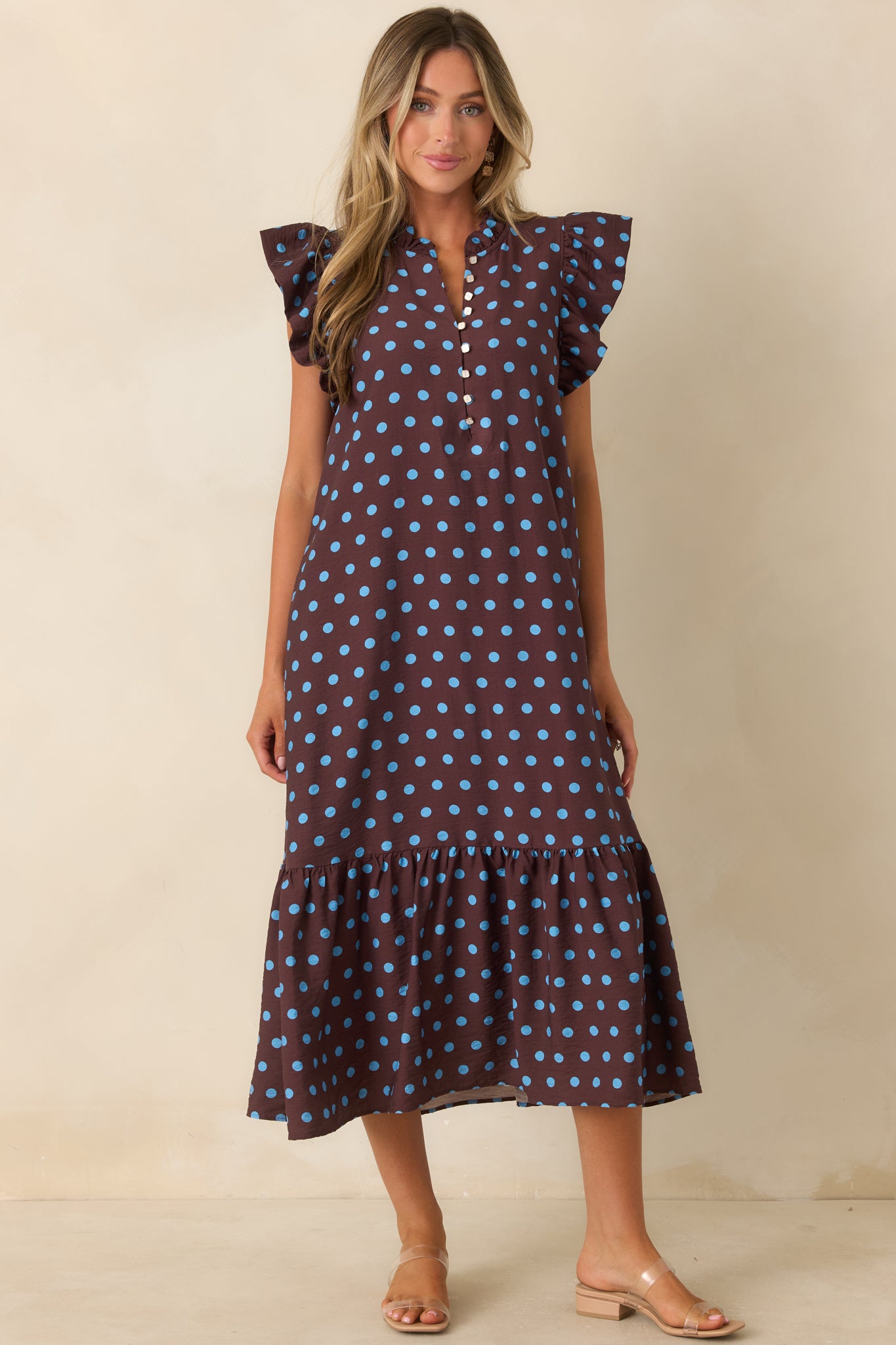 Brown polka dot dress with a charming button neckline, ruffle trim, comfortable shape, and tiered silhouette.
