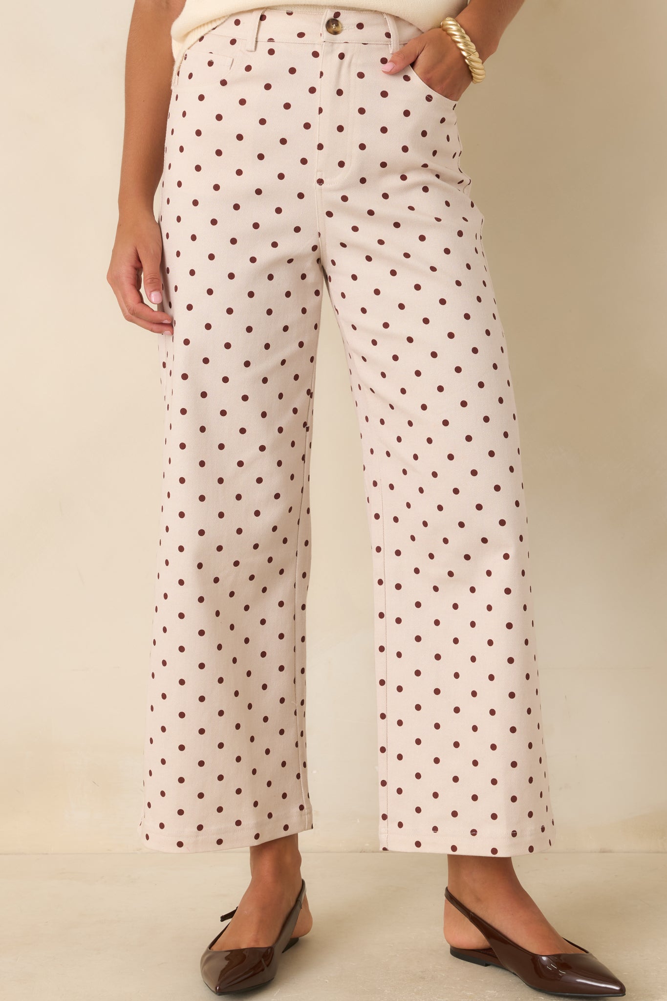 Rich brown polka dots highlight the smooth stretch cotton blend fabric of these wide-leg pants.