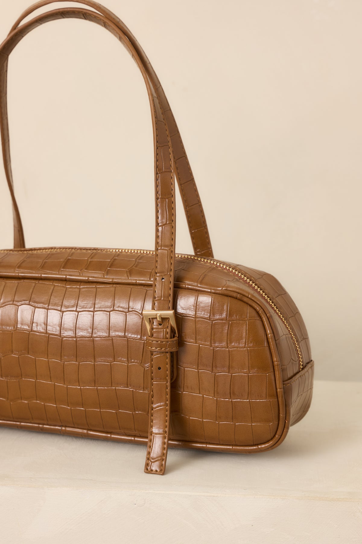 Close-up of the handbag's raised croc-embossed pattern, smooth faux leather finish, and refined structured construction.