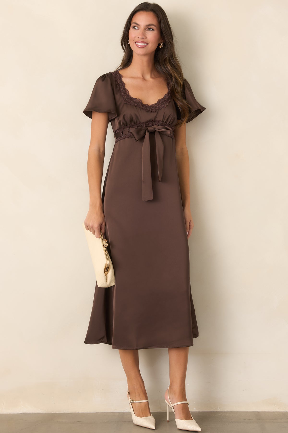 Smooth brown satin dress with short flutter sleeves, a gathered bodice, and softly flared skirt.