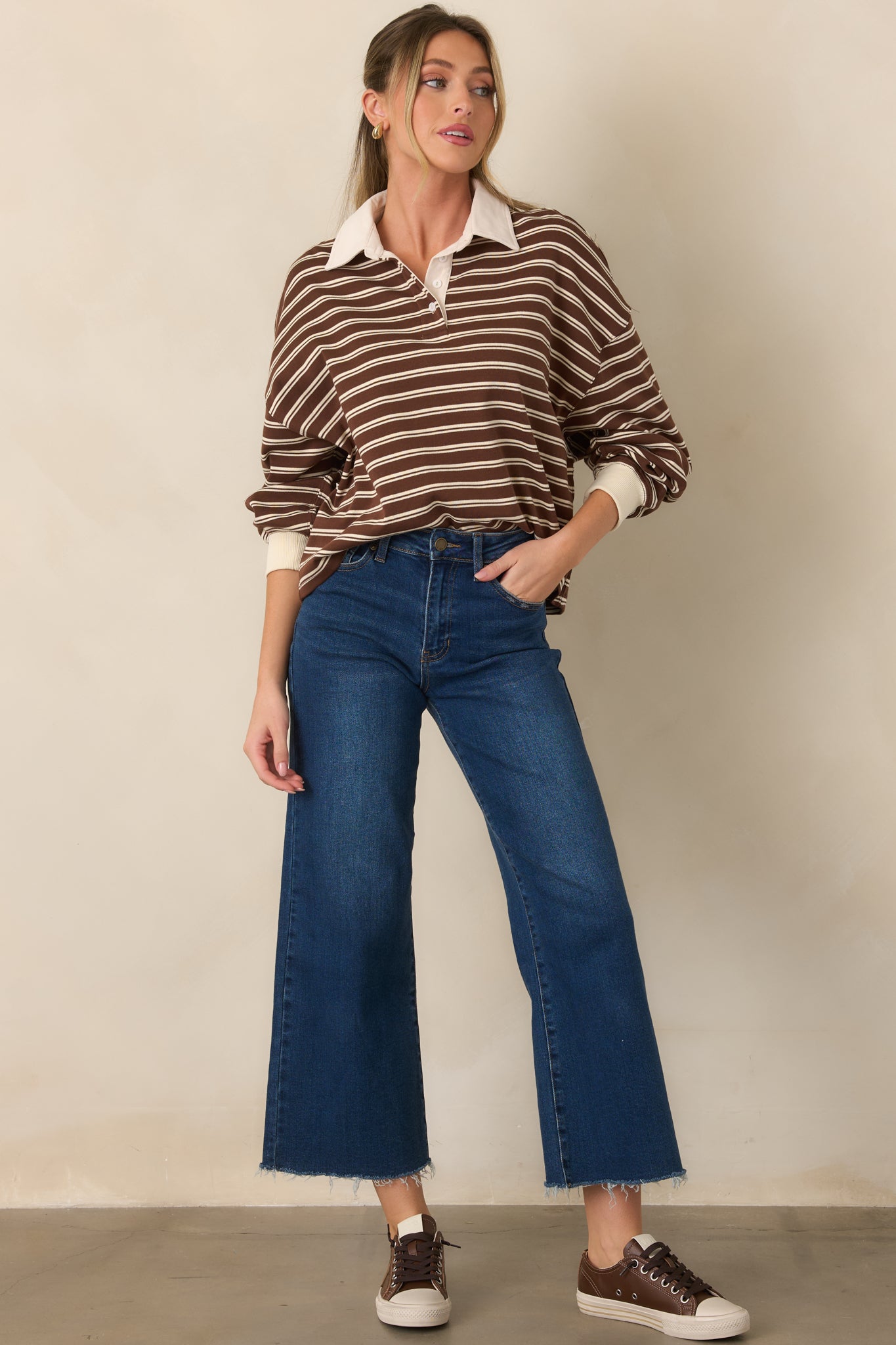 Striped brown knit top with an oversized ivory collar, relaxed dropped shoulders, and long sleeves finished with ivory cuffs.
