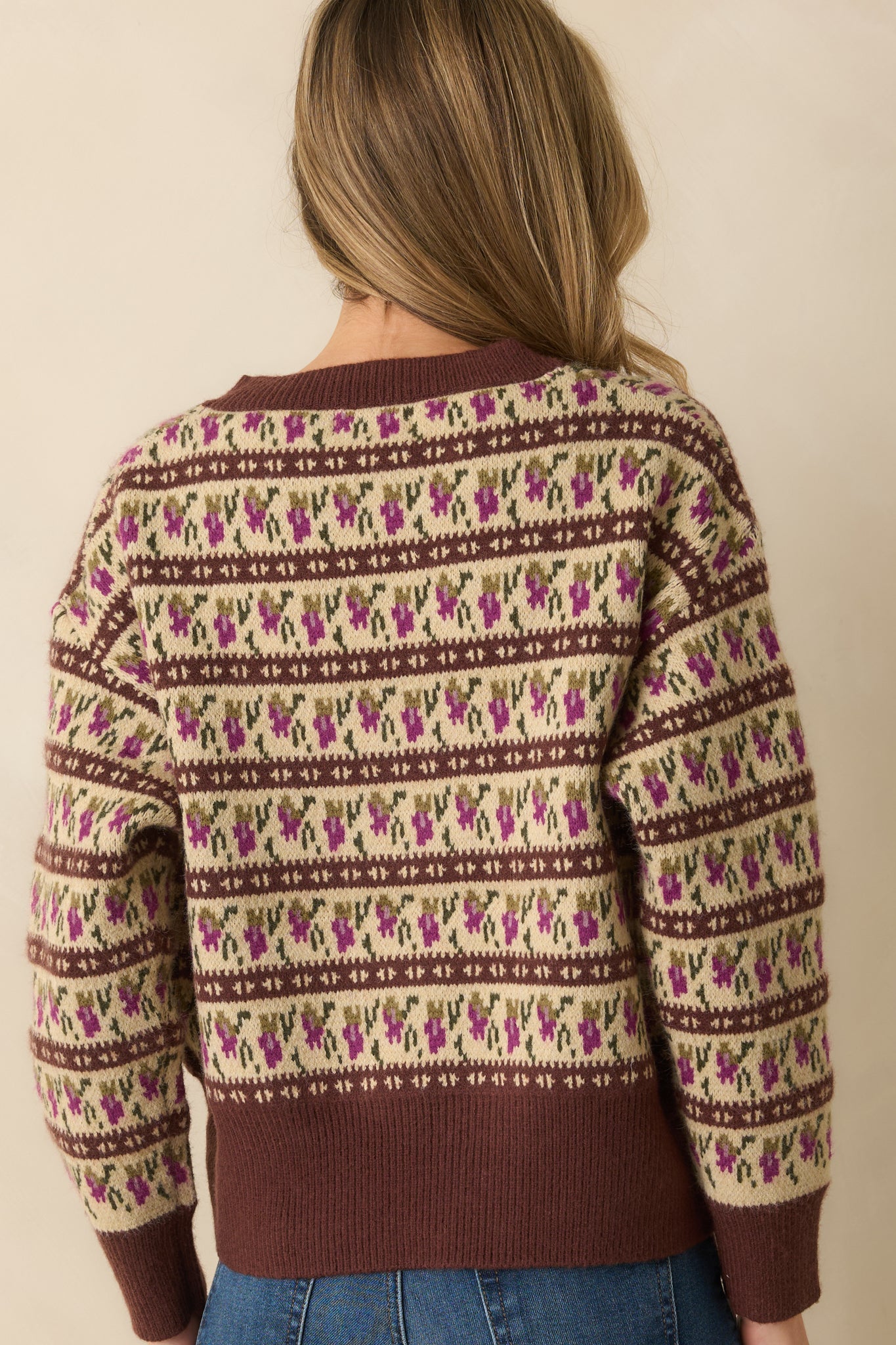 Rear view of the brown sweater showing the full Fair Isle pattern across the back and long sleeve silhouette.