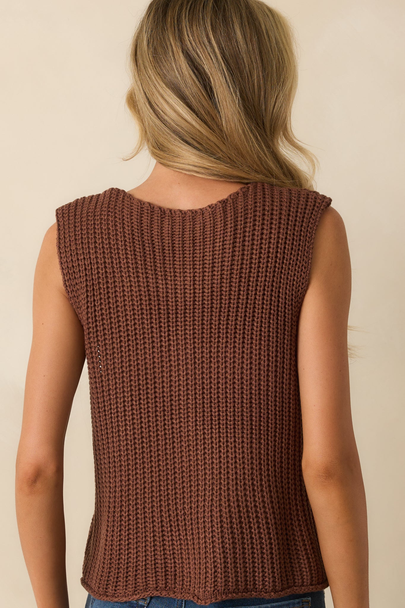 Back view of the brown sweater vest showing clean ribbed knit and straight hem