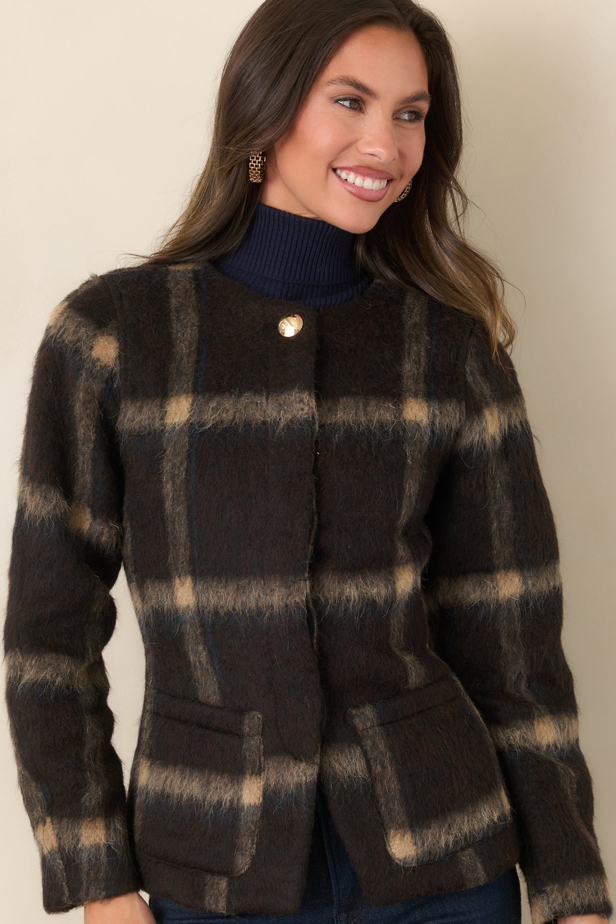Rich brown jacket featuring tan plaid lines, a round neckline, and a concealed button front.