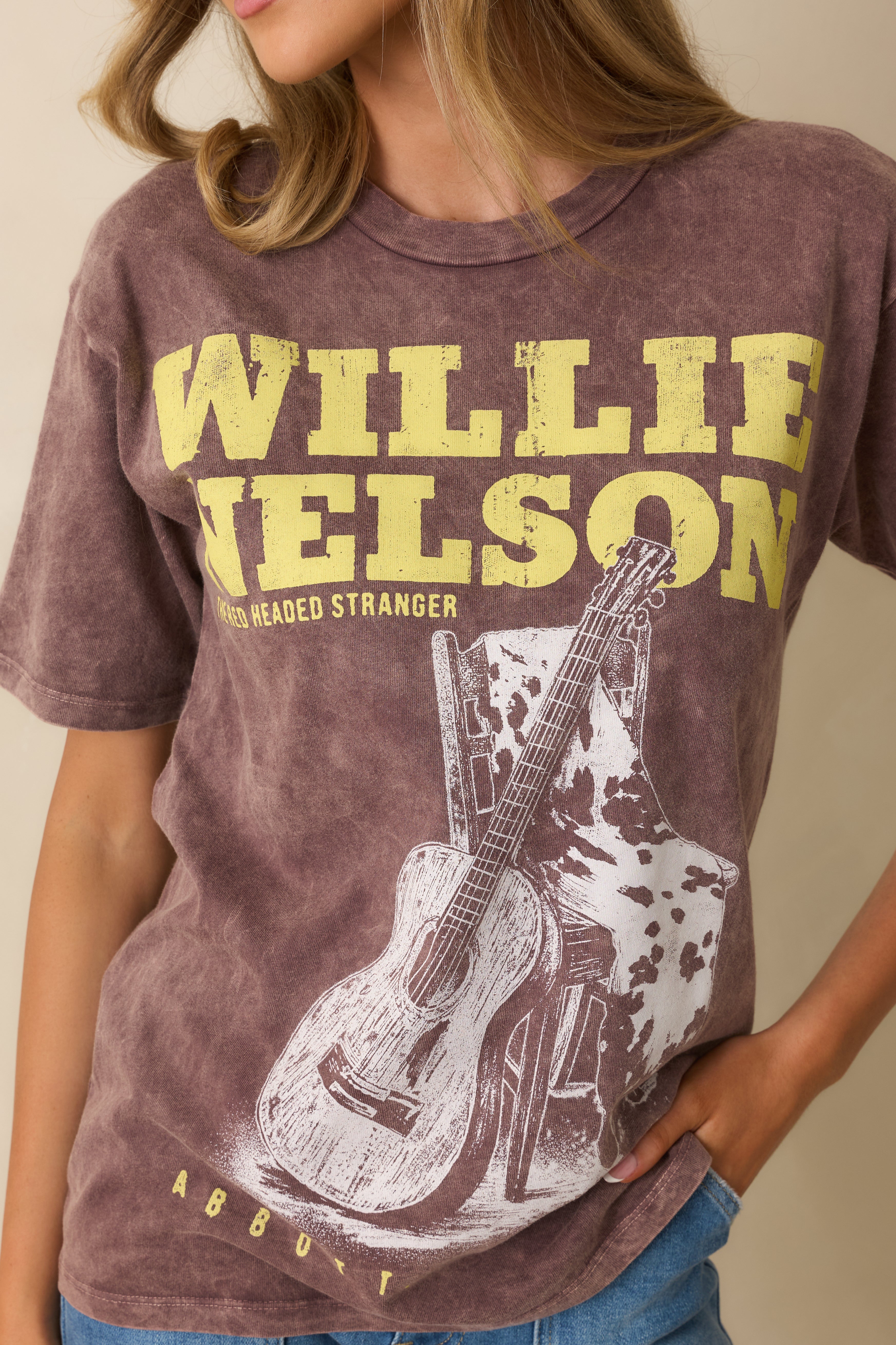 Close-up of the graphic print, distressed fabric, and vintage wash texture.