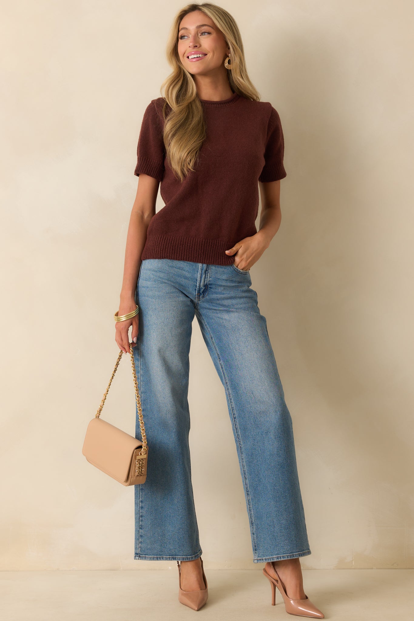 Front view of brown top highlighting short sleeves and crew neckline.