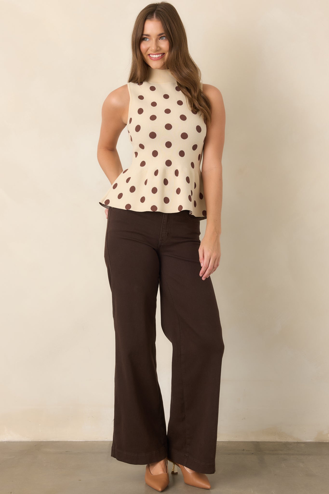 Wide-leg denim pants with a deep brown wash, defined high-rise waistband, traditional pockets, and relaxed structured shape.