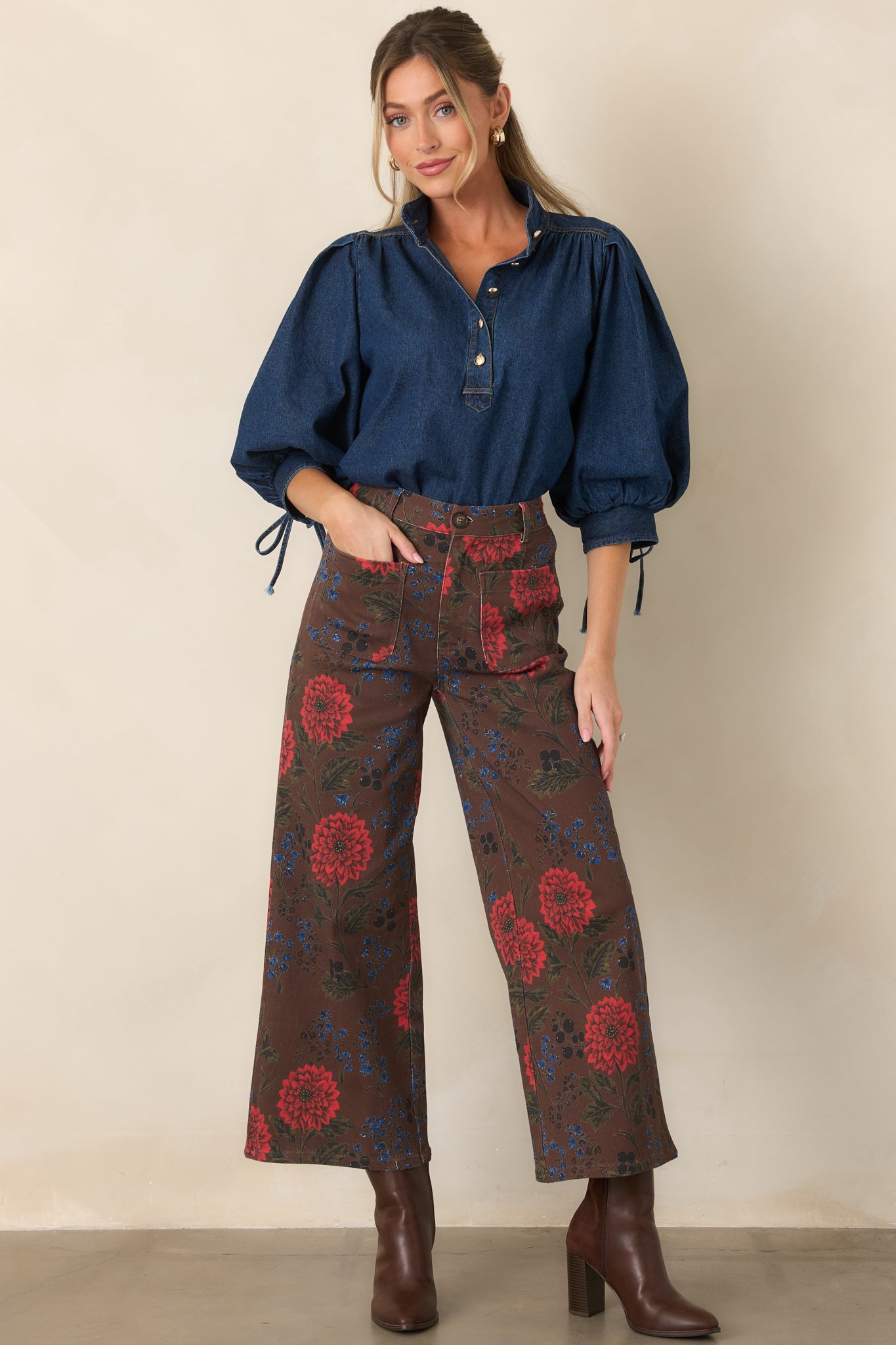 Structured brown pants with a cropped wide-leg silhouette, colorful floral motifs, and oversized utility-style patch pockets.