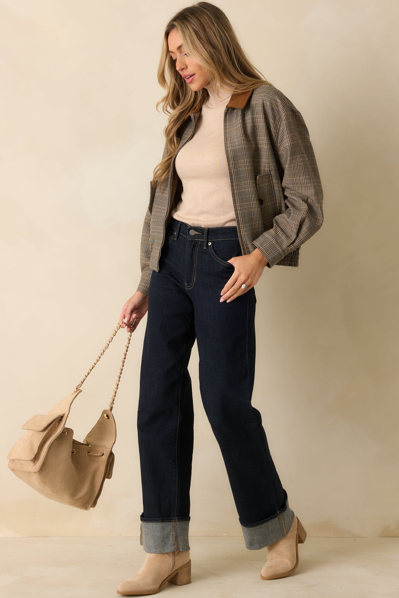 Brown woven bomber jacket featuring multi plaid pattern, flap pockets, and relaxed fit silhouette.