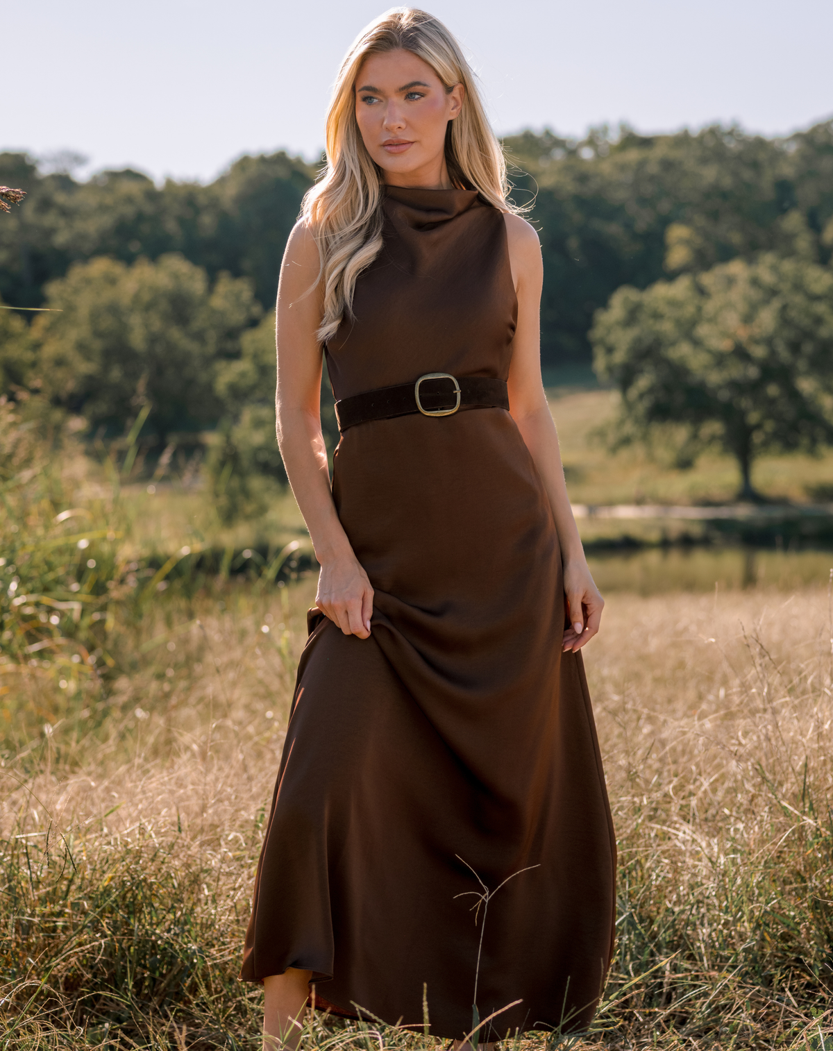 Model wearing a brown dress, with a brown suede belt.