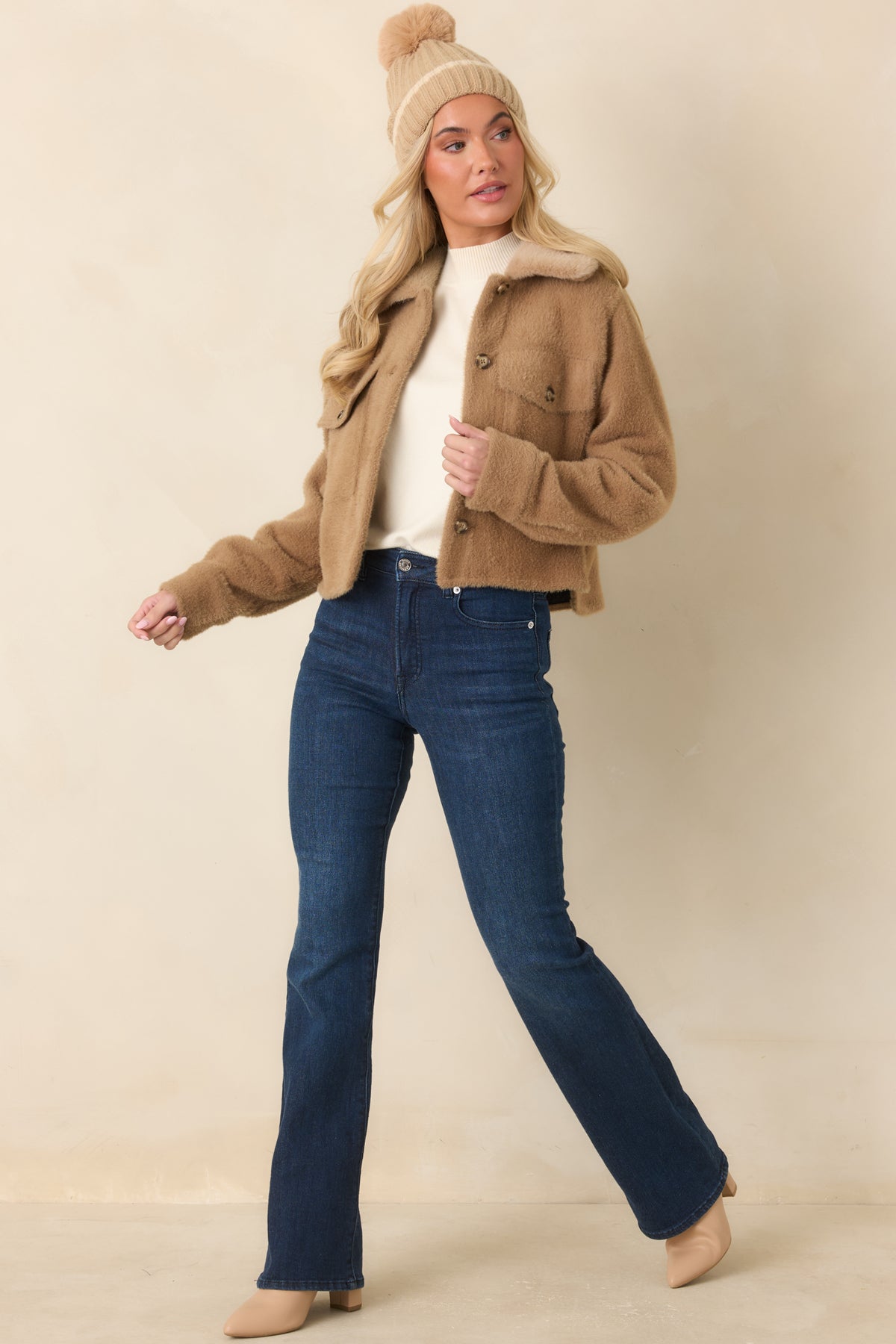 Brushed camel jacket with tonal fur trim, a structured button placket, and classic chest pockets.
