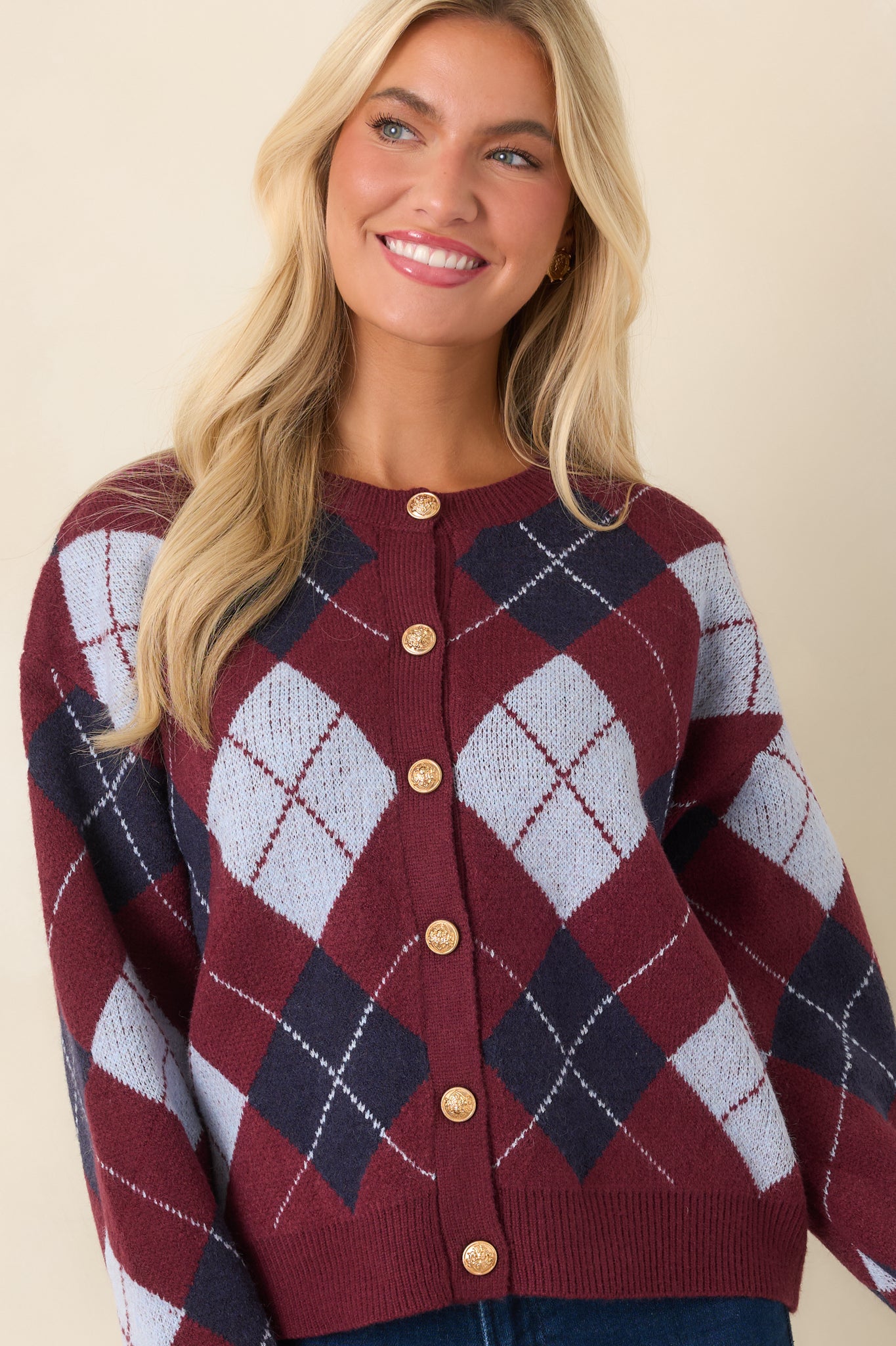 Ribbed cuffs and hem add texture to this relaxed burgundy cardigan with gold hardware.
