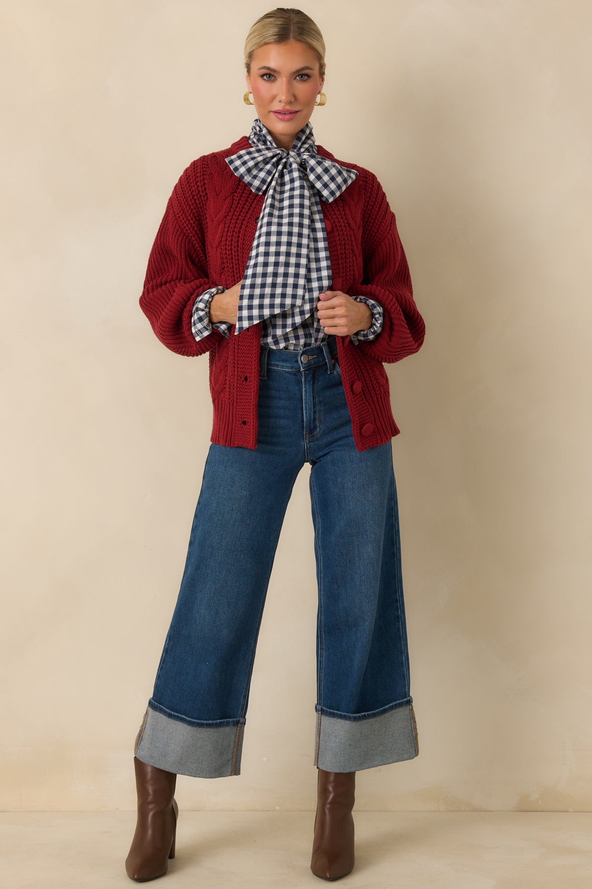  Cotton-blend cardigan in burgundy with chunky front cables contrasted by ribbed texture through the sleeves.