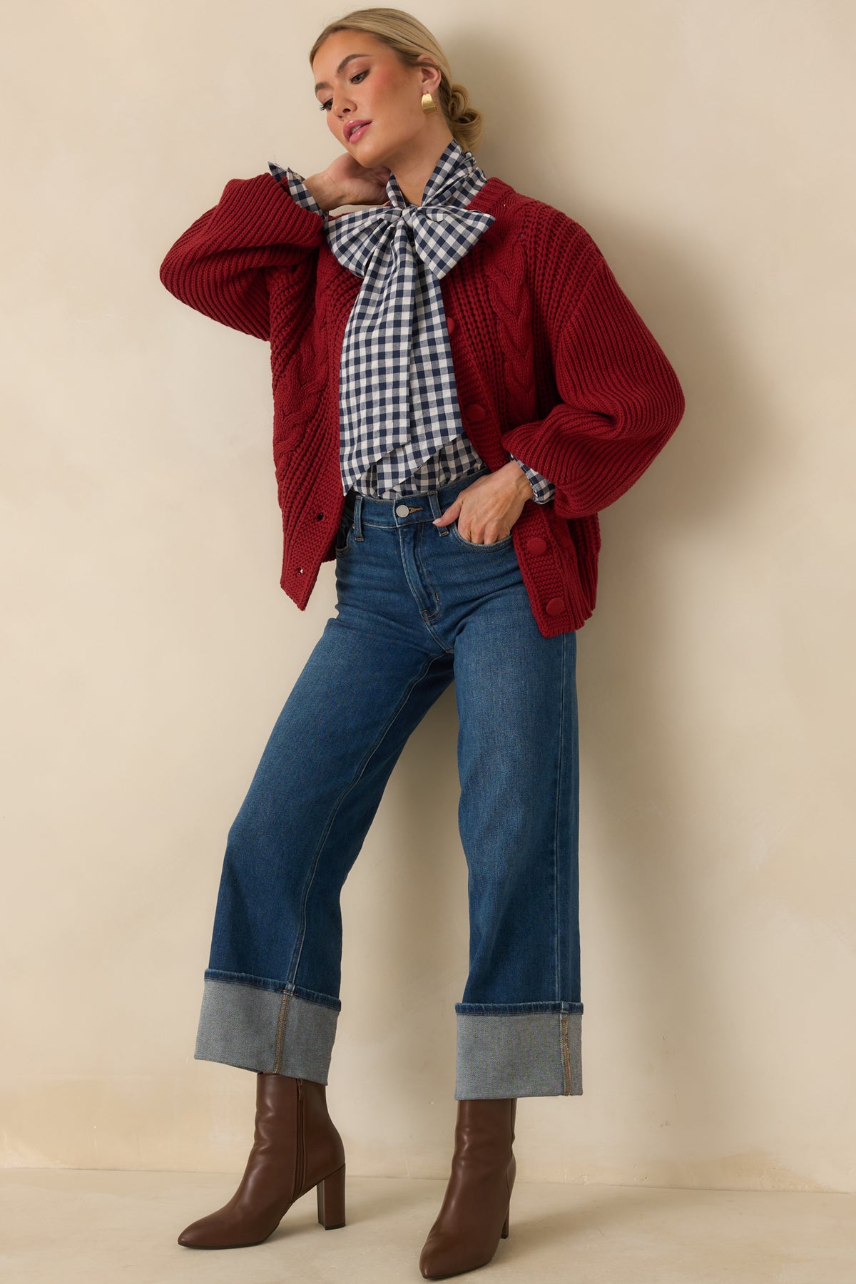 Burgundy cotton-blend cardigan with chunky cable-knit detailing down the front and tonal knit-covered buttons.