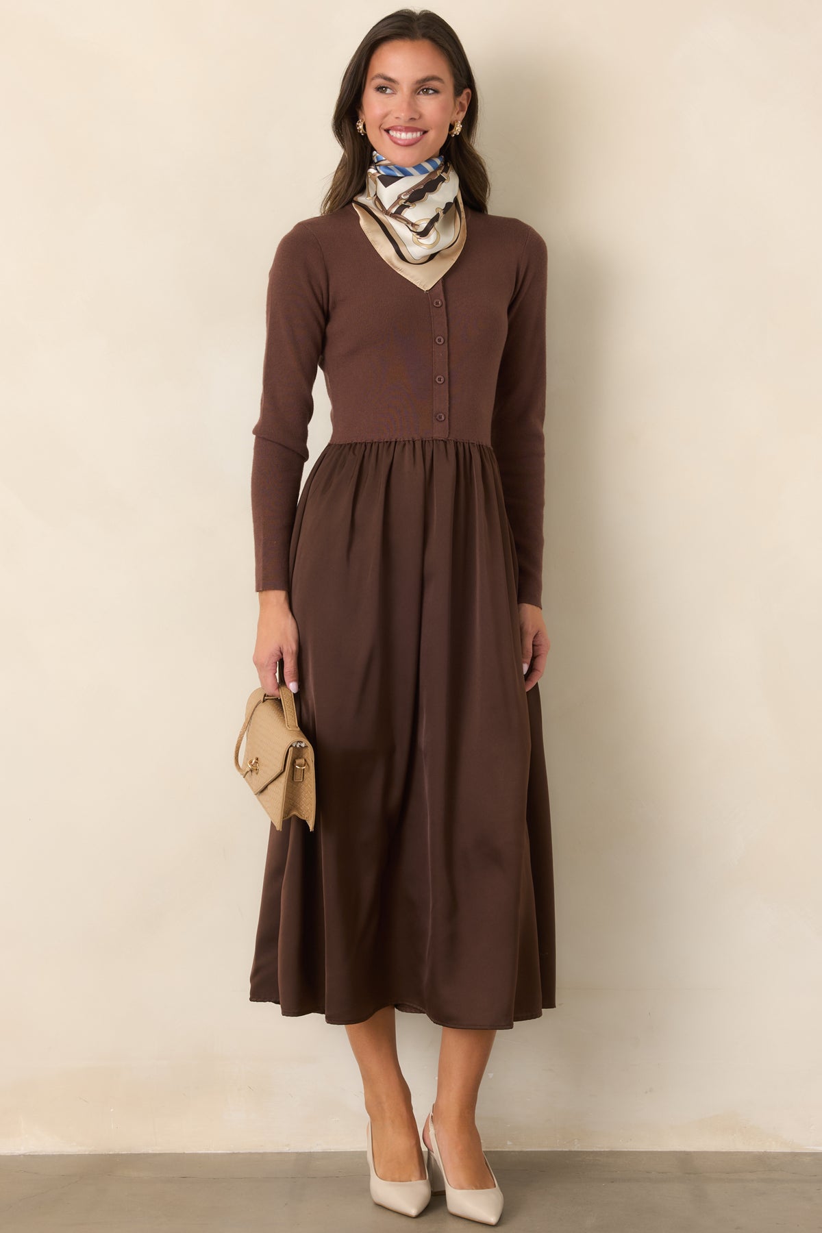 Burgundy dress featuring a defined waist and gathered satin skirt with a gently flared silhouette.