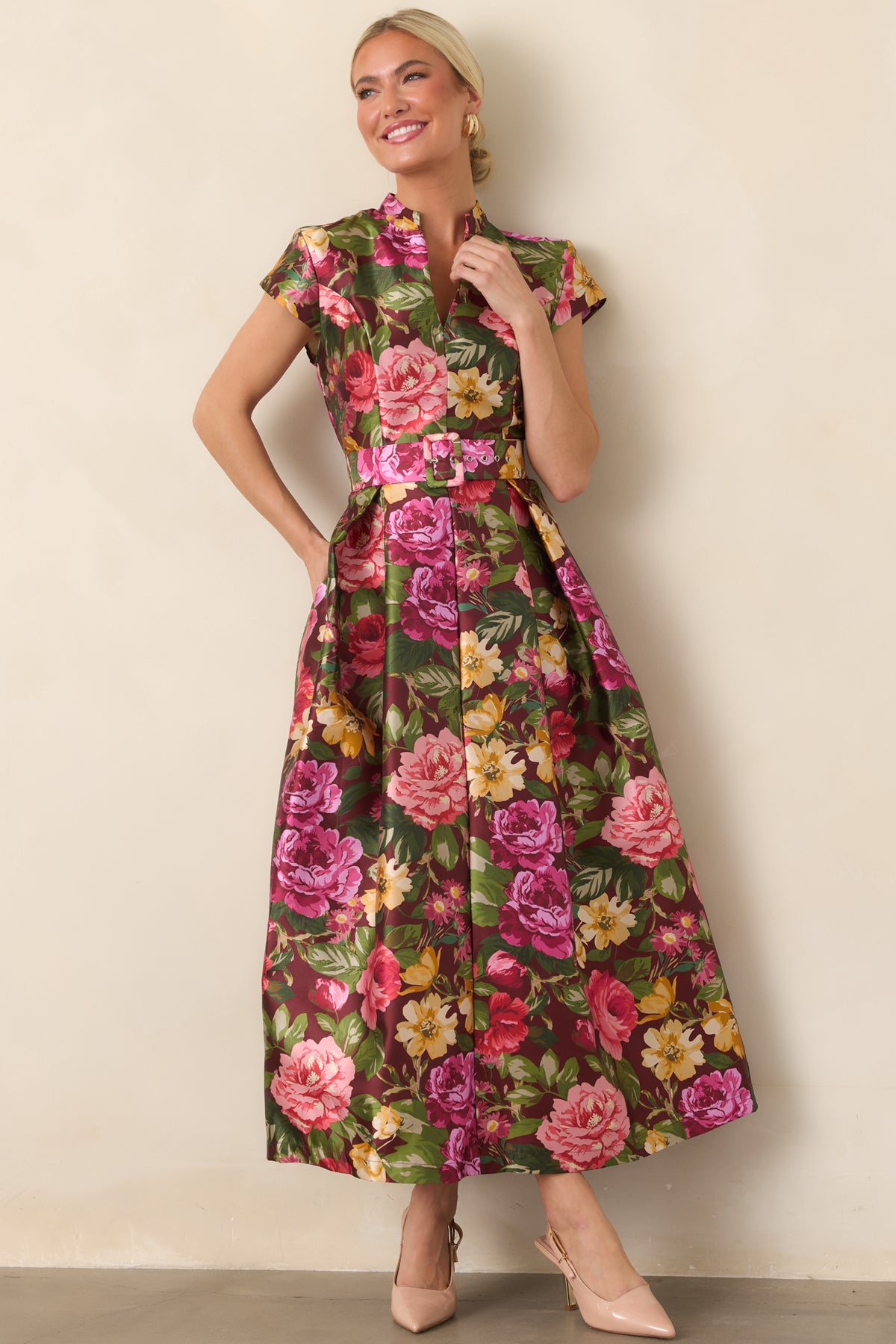 Romantic burgundy dress showcasing pink, coral, golden yellow, and green florals across a fitted bodice and flowing skirt.
