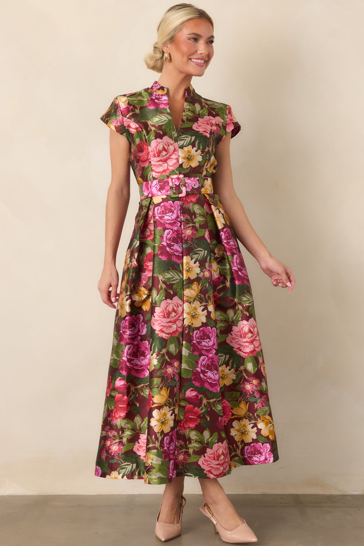 Burgundy floral dress with a fitted bodice, defined waist, removable fabric belt, and graceful pleated skirt.