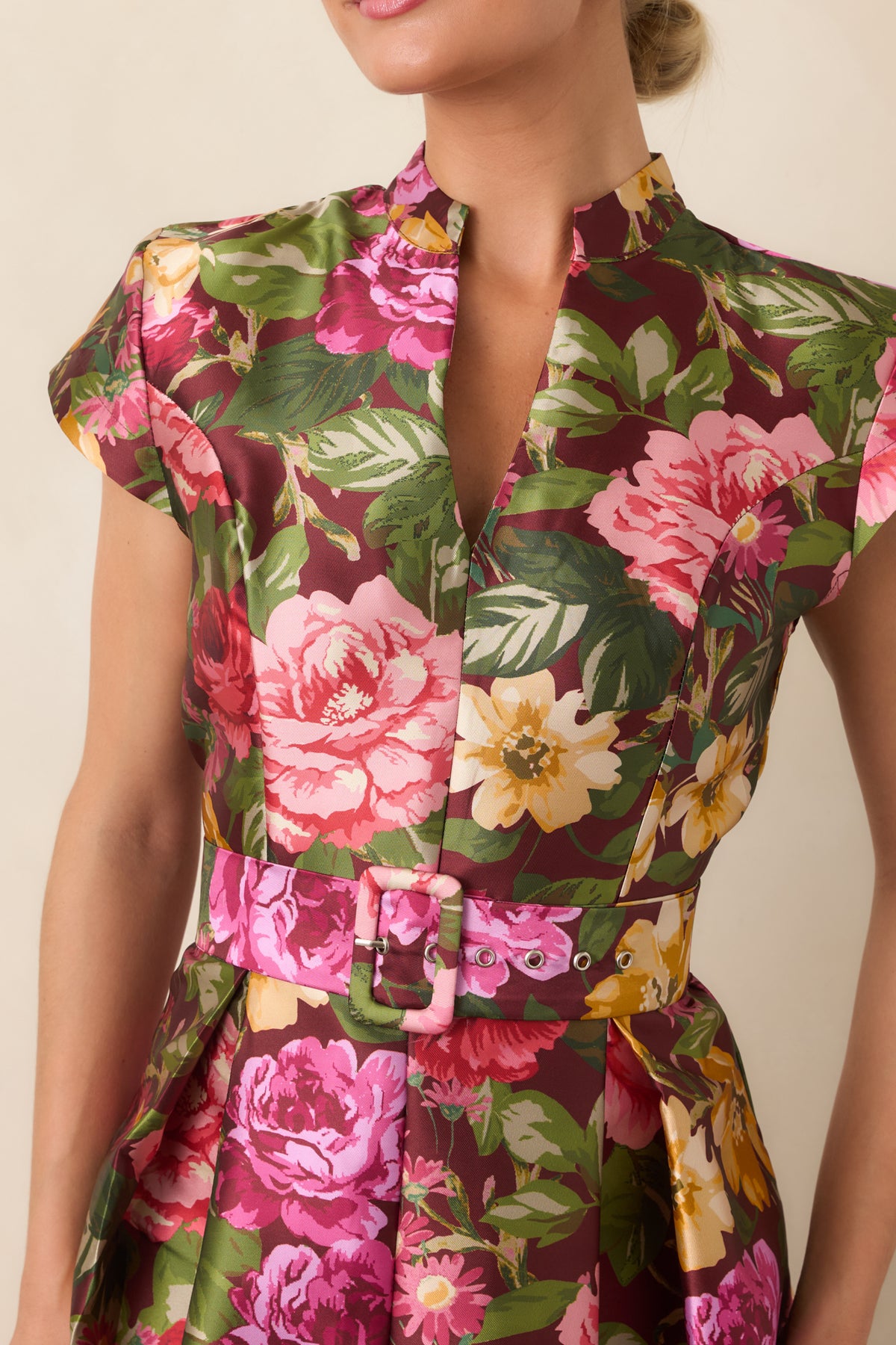 Close-up of the burgundy floral dress highlighting the notched stand collar, cap sleeve structure, and vibrant print.