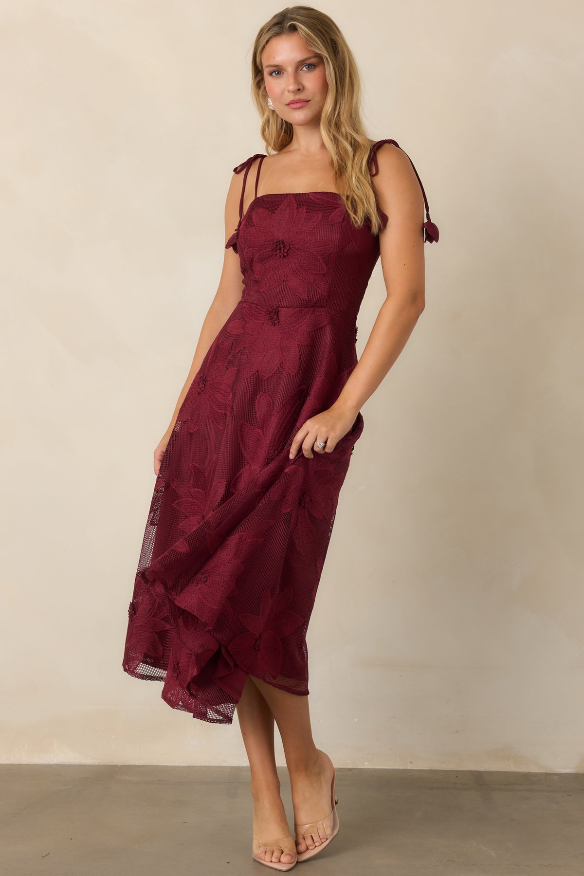 Burgundy floral lace dress showcasing the fitted bodice, straight neckline, and sweeping A-line skirt.