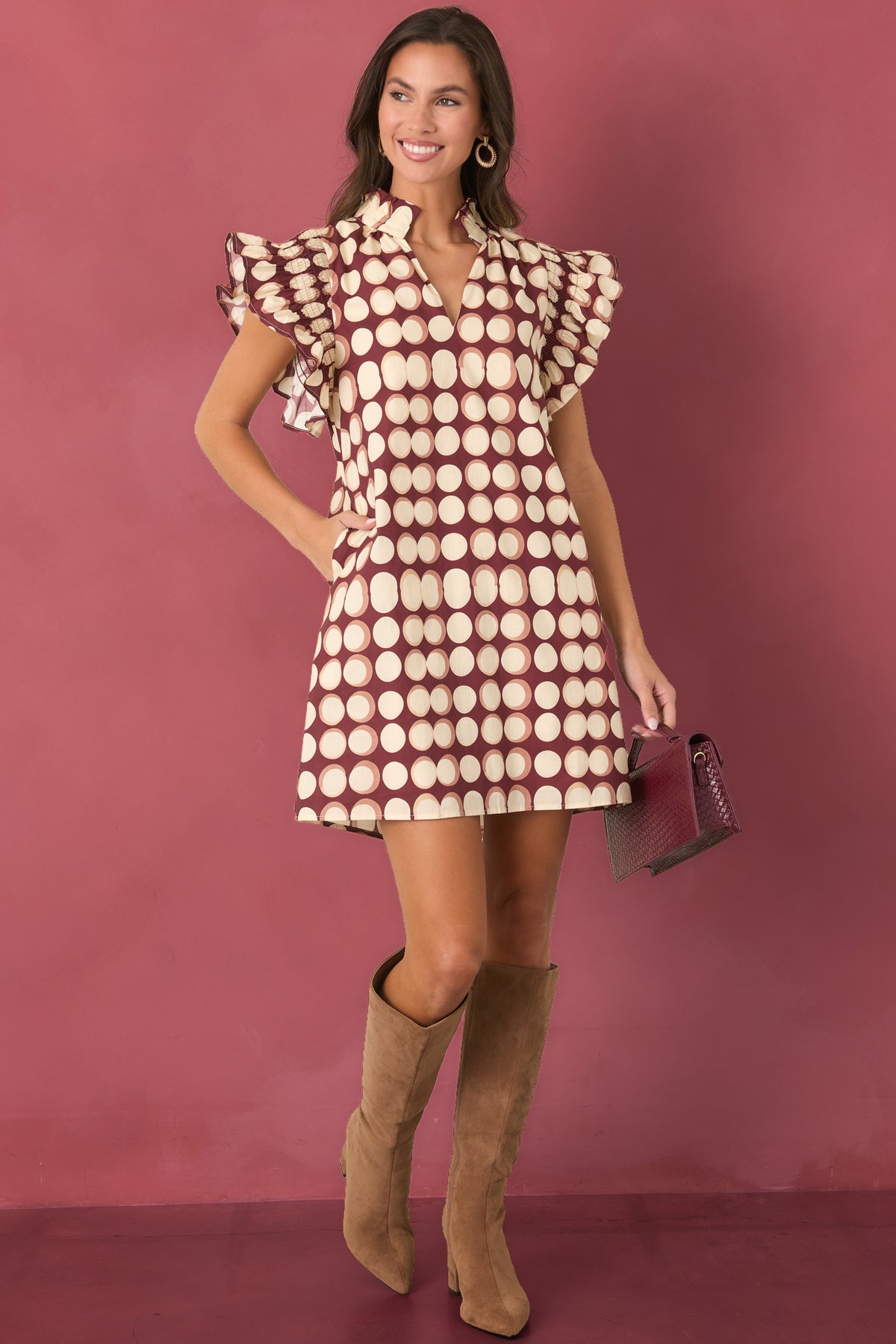Burgundy cotton mini dress with oversized ivory dots, ruffled stand collar, split neckline, and short flutter sleeves.