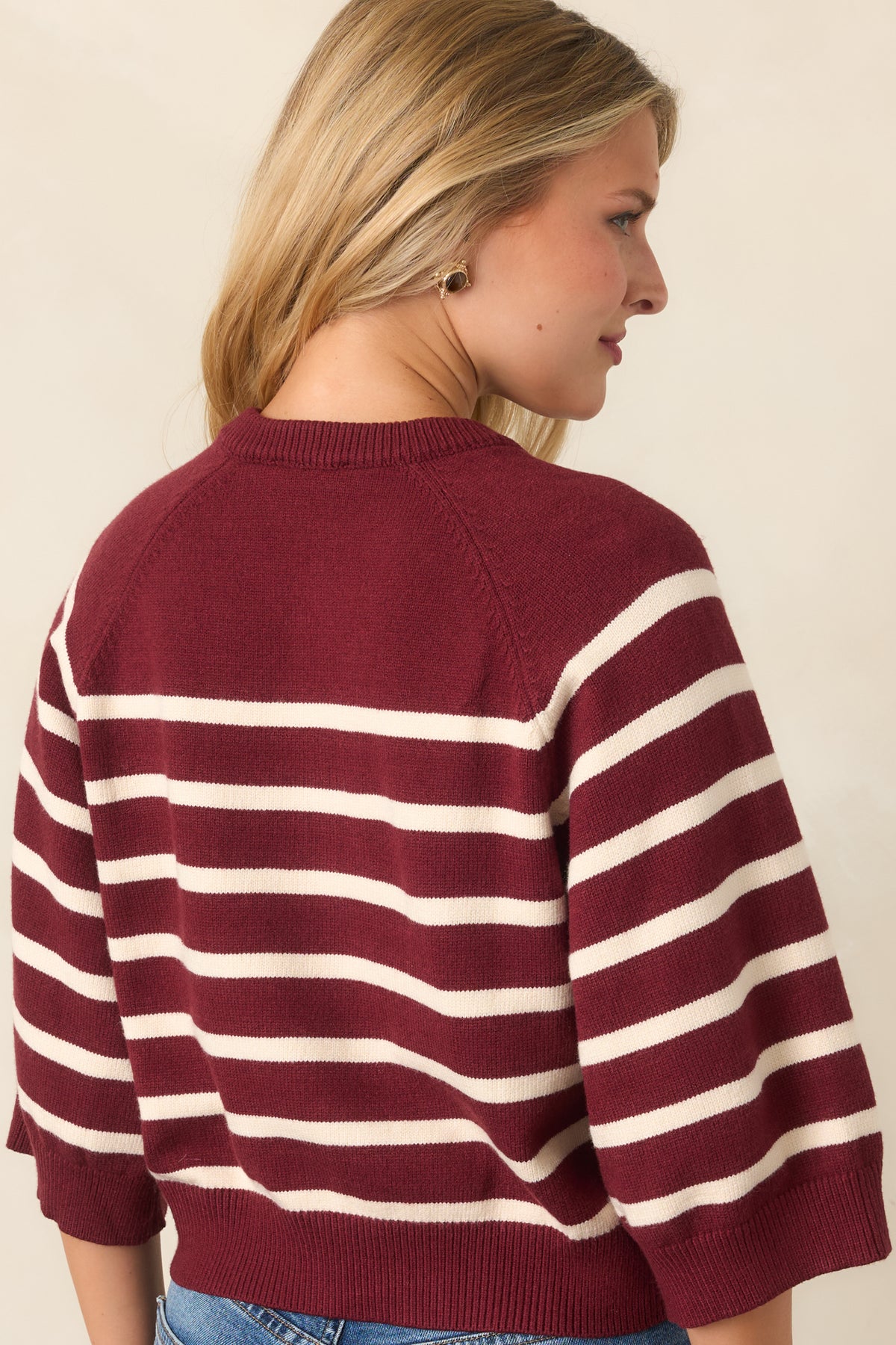 Rear of the burgundy and ivory knit top showcasing its relaxed boxy silhouette and ribbed hem.