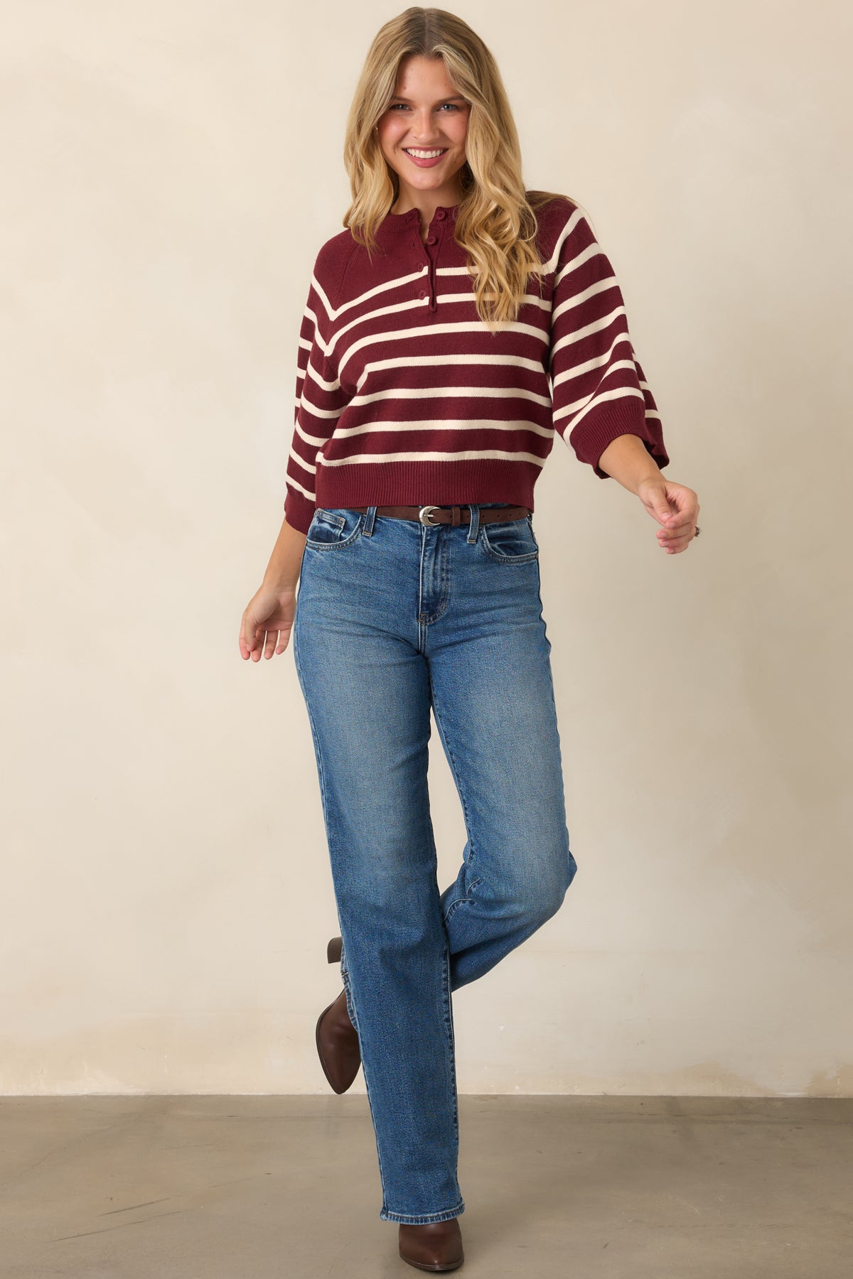 Burgundy and ivory knit top featuring a round neckline and partial button-front placket.