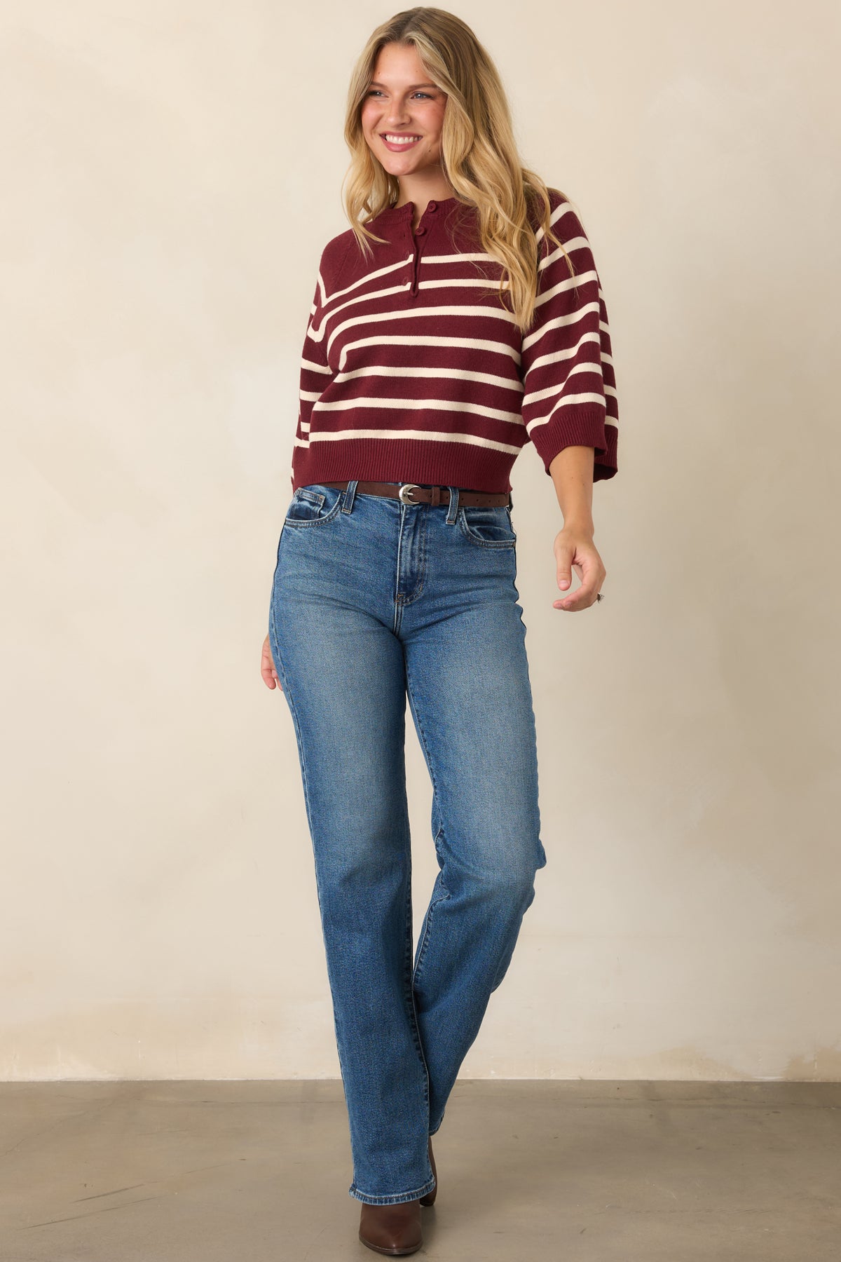 Burgundy and ivory knit top emphasizing the wide sleeves, banded design, and relaxed silhouette.