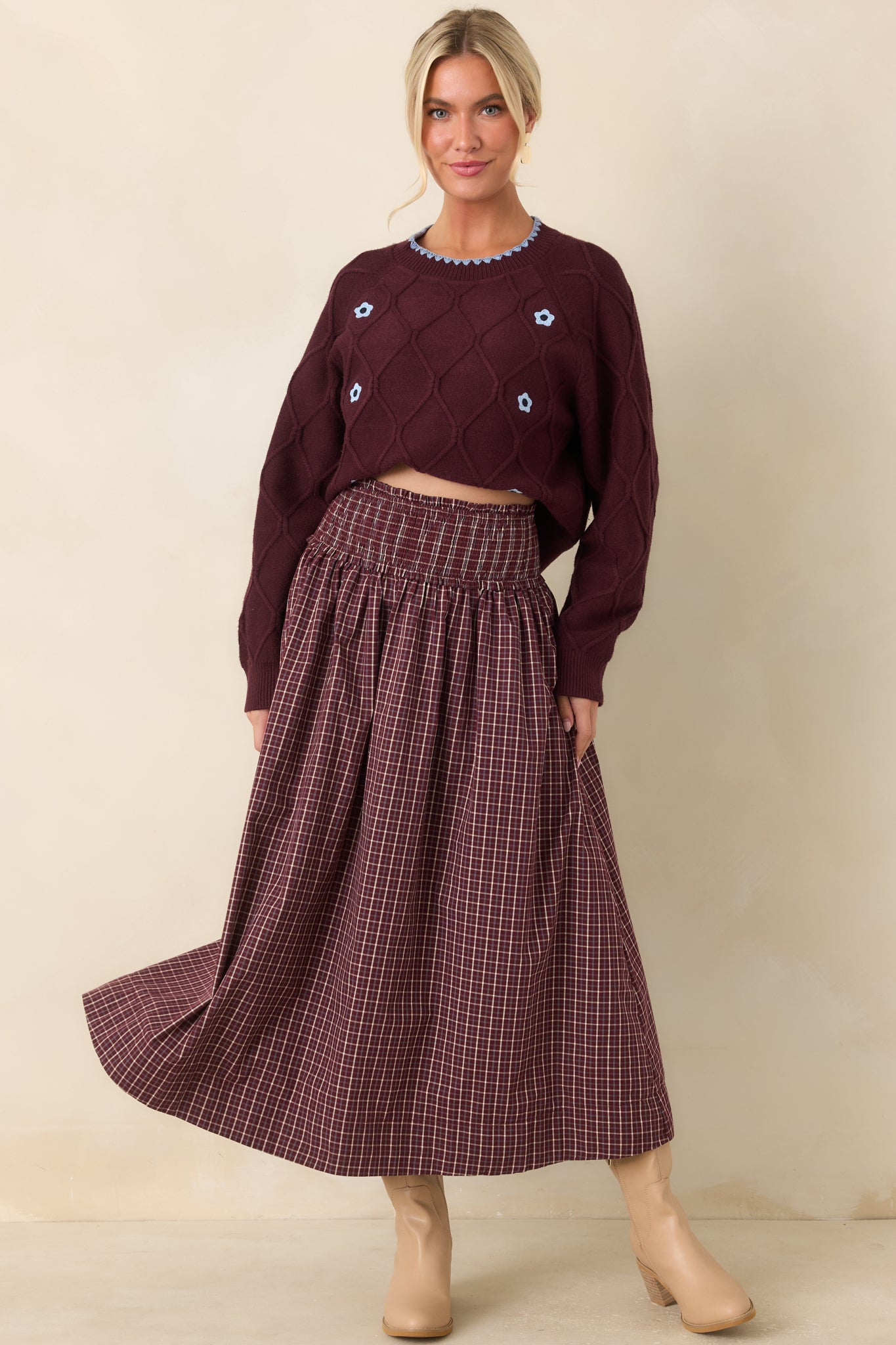 Burgundy, ivory, and light blue plaid maxi skirt crafted from 100% cotton with a wide smocked drop waist and subtle ruffle trim.